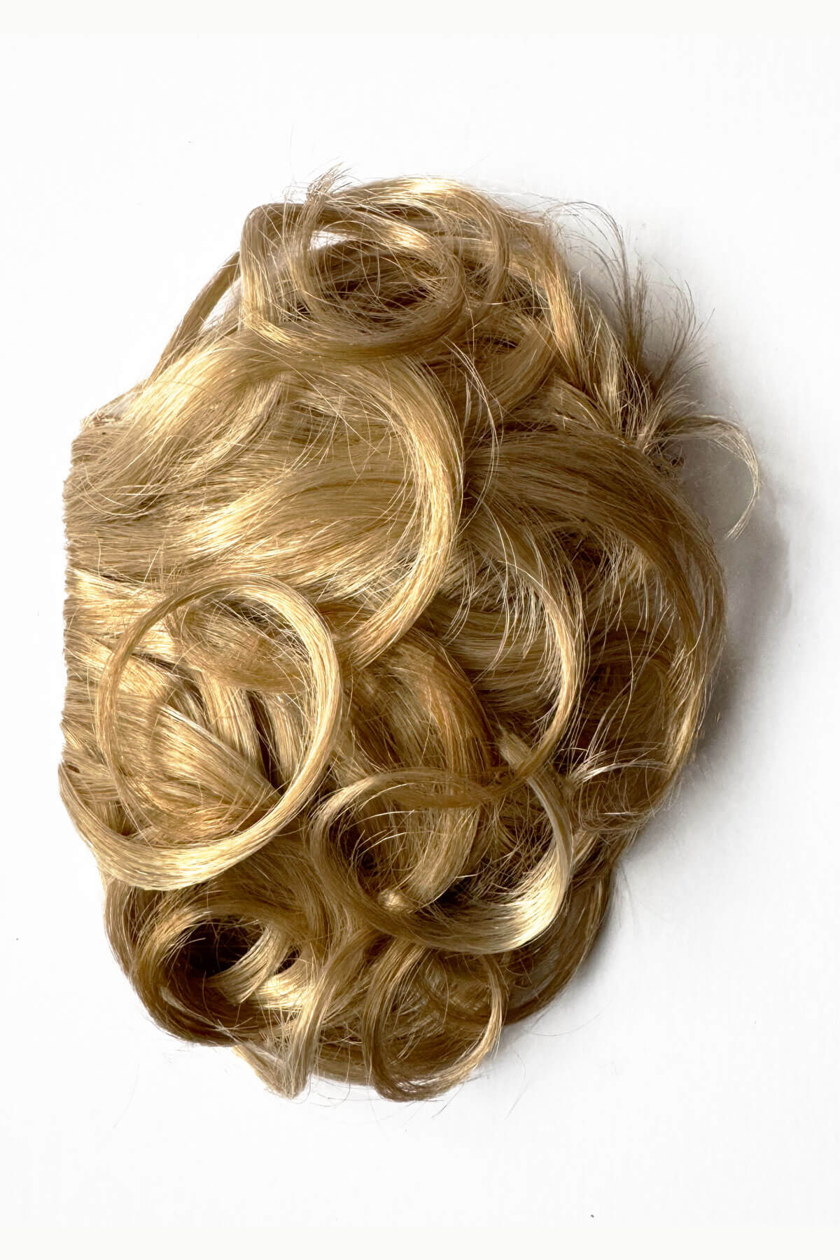Blonde hair bun accessory on a white background. Curly 1940s style clip-in fringe hairpiece/clip-in bangs: Bunny blonde 613T24