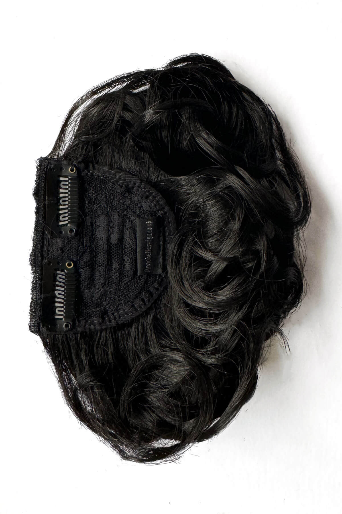 Black hair extension on a white background. Curly 1940s style clip-in fringe hairpiece/clip-in bangs: Bunny black 1B