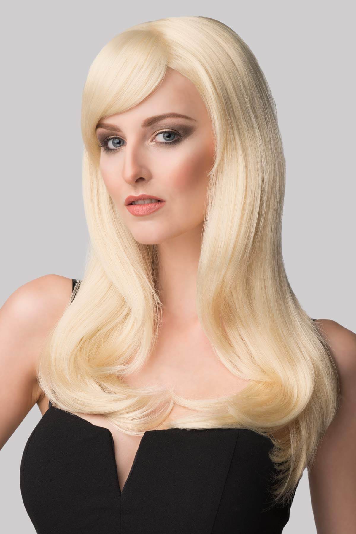 Woman with long blonde hair wearing a black top against a gray background. Long blonde wig, face framing with long, side-sweeping fringe: Ashley blonde 613