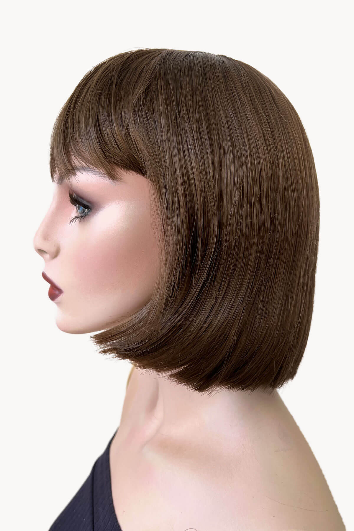 Woman with a stylish bob haircut on a white background. Brown bob wig, chic and stylish: Honour mocha brown 10