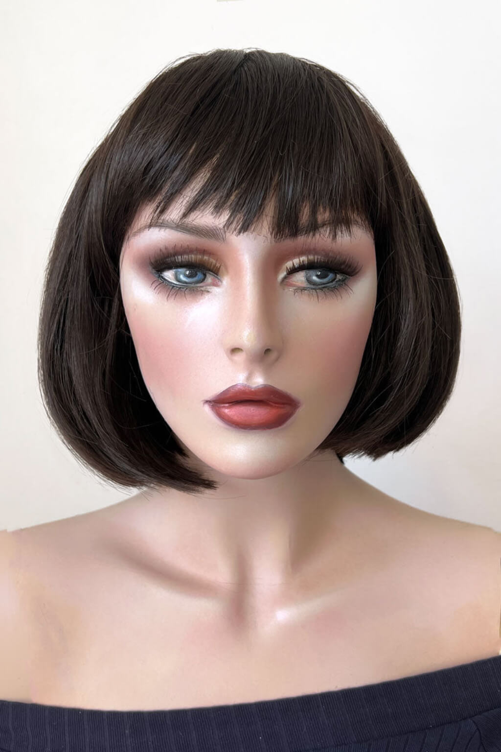 Mannequin head with a black bob wig on a white background. Brown bob wig, chic and stylish: Honour dark brown 4