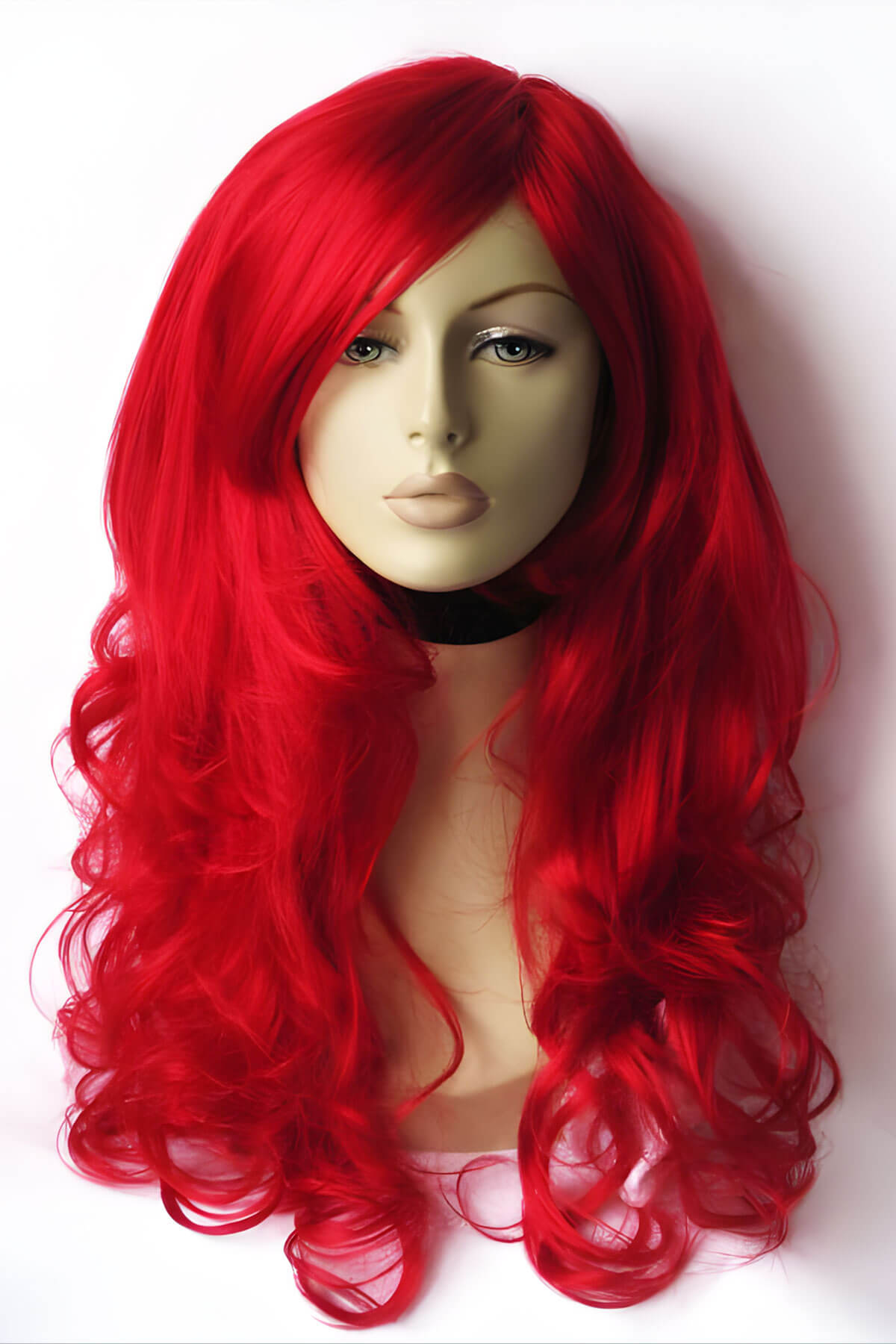 Red wig on a mannequin head against a white background. Long bright red wig with long, big loose curls: Alexis