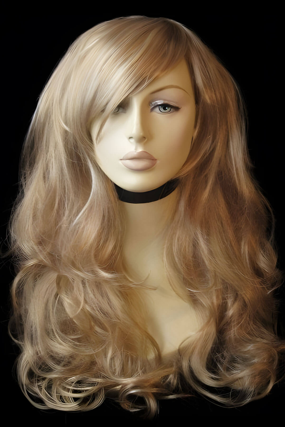 Blonde wig on a mannequin head against a black background. Blonde wig with big loose curls and sweeping fringe, extra long: Carly ash blonde and light blonde 24H613