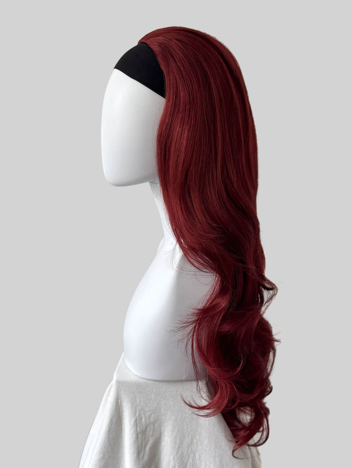 Red wig on a mannequin head against a white background. Red half wig hairpiece (3/4 wig), big loose curls: Verity copper red and wine red 350-39
