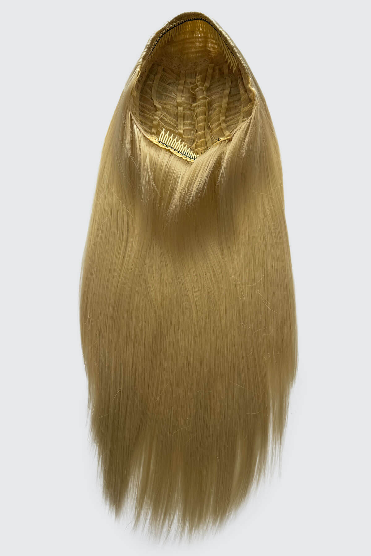 Blonde hair extension with a clip on a white background. Straight blonde half wig hairpiece (3/4 wig): Tabitha creamy blonde 613