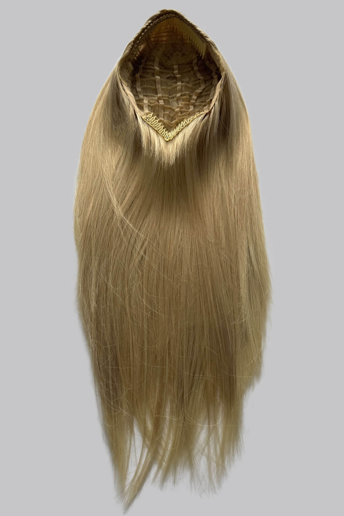 Blonde hair extension on a gray background. Straight blonde half wig hairpiece (3/4 wig): Tabitha blonde 613T24