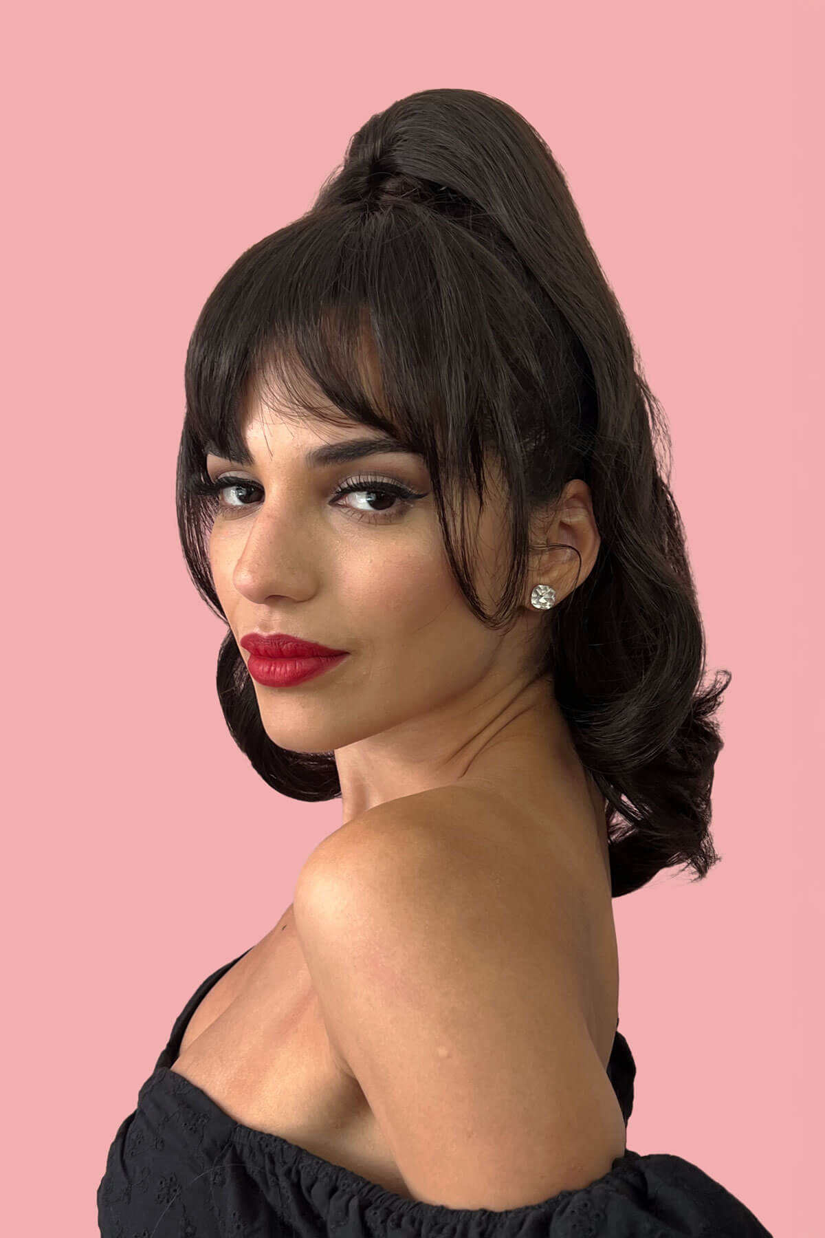 Woman with a stylish hairdo and red lipstick against a pink background. Clip in fringe hairpiece/clip-in bangs, gently feathered with face framing whisps: Delia dark brown 6