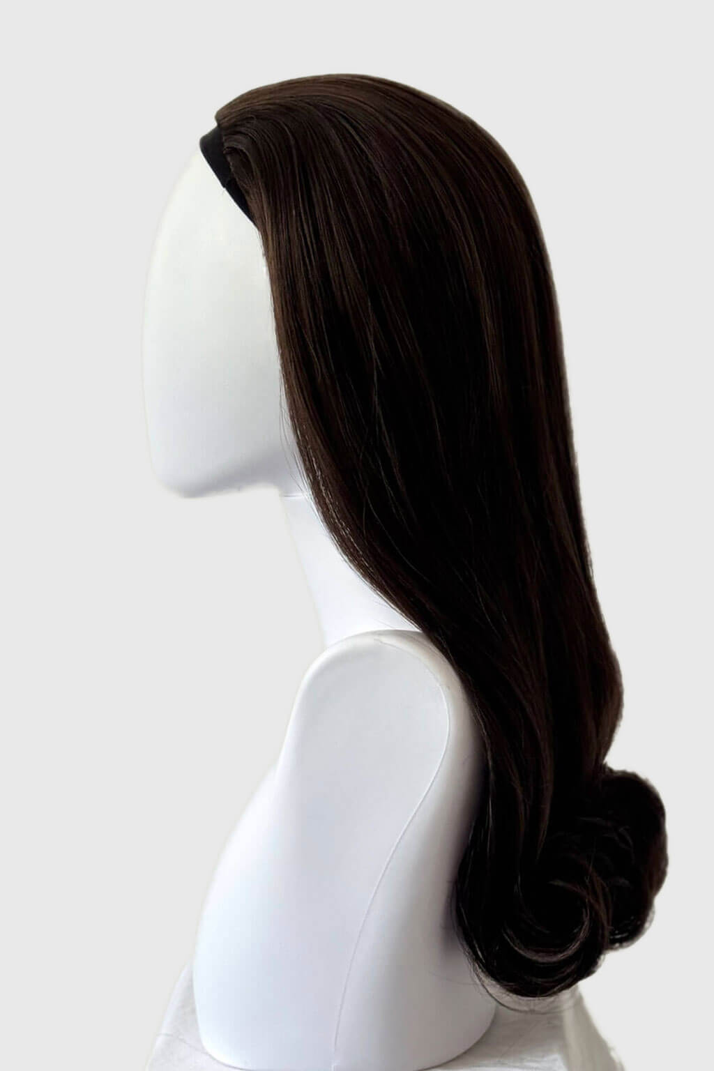 Dark brown wig on a mannequin head against a white background. 1960s Retro high crown, half wig hairpiece, long with hair flip: Priscilla chocolate brown 6
