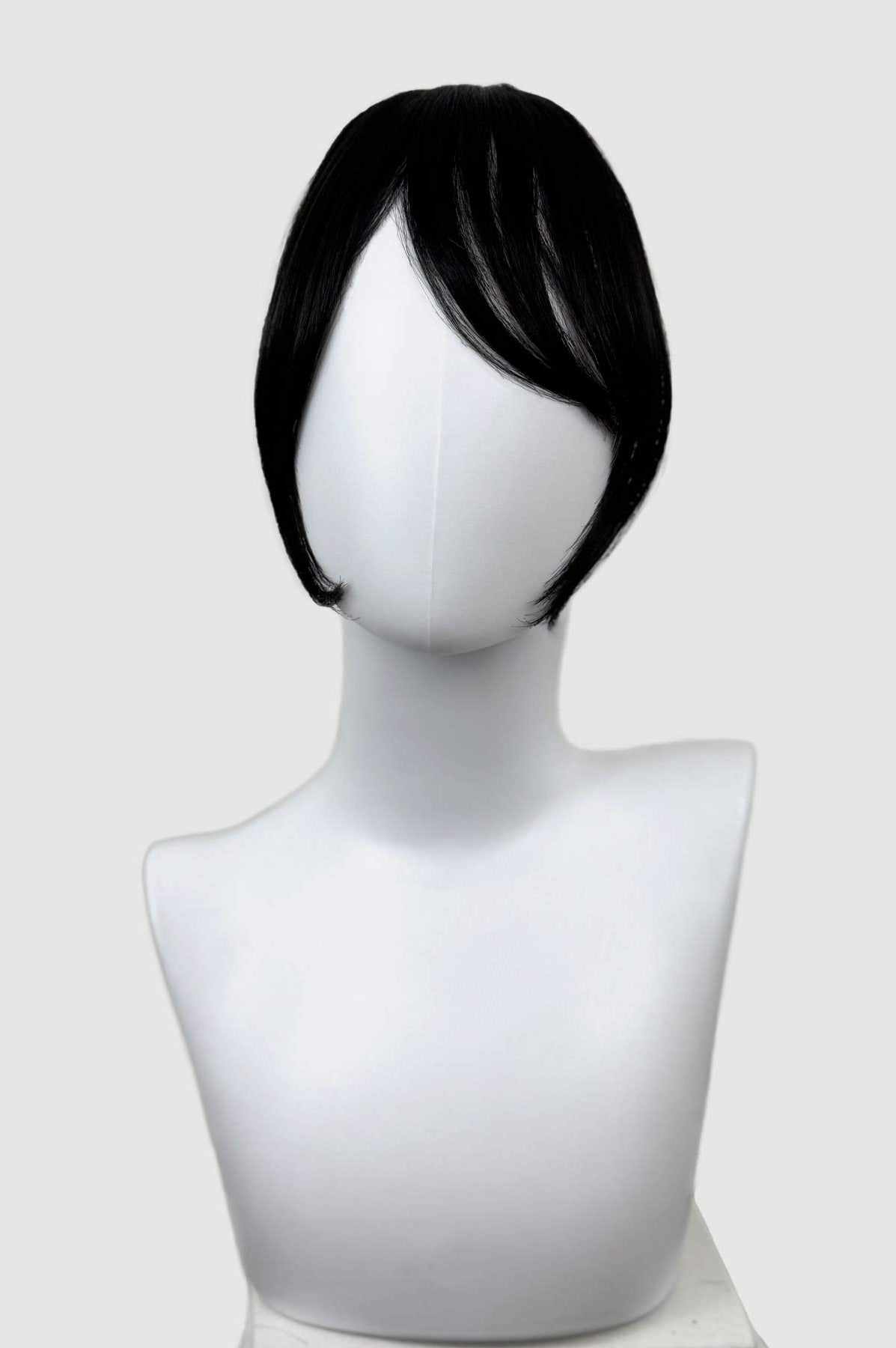 Black wig on a mannequin head against a white background. Clip in fringe hairpiece/clip-in curtain bangs, with long, face framing wisps: Sabrina black 1b
