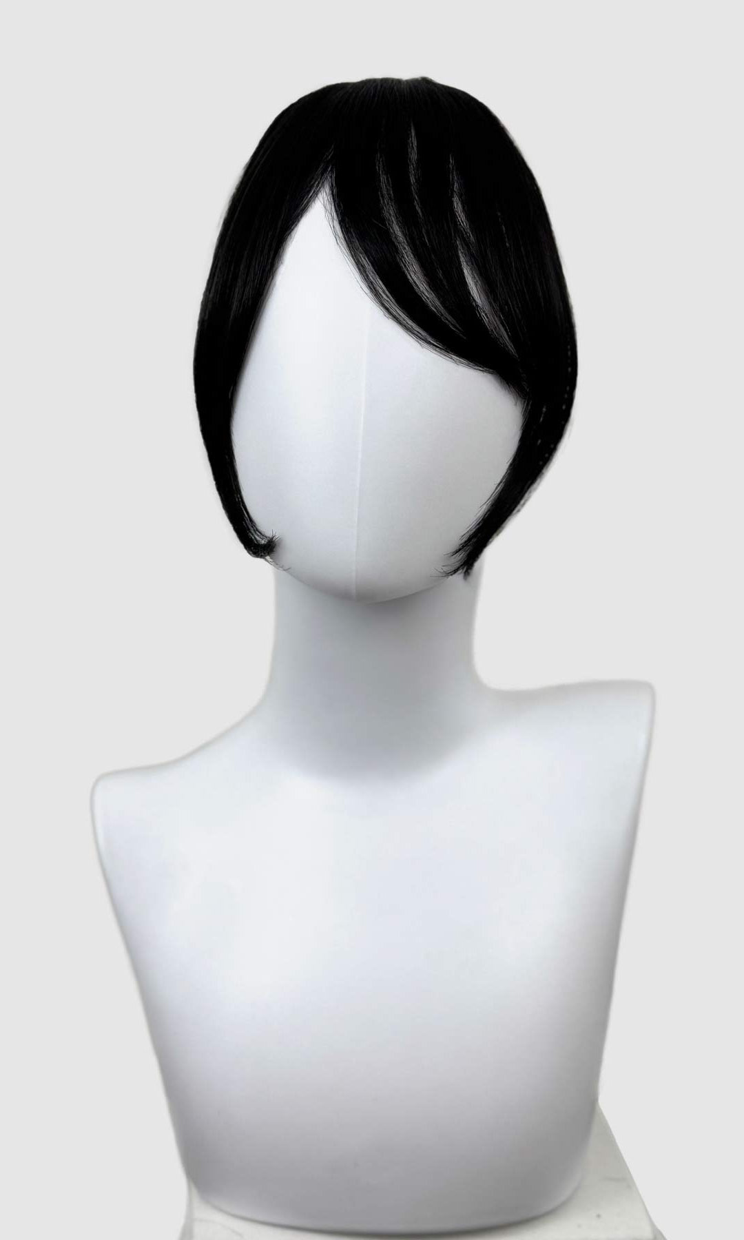 Black wig on a mannequin head against a white background. Clip in fringe hairpiece/clip-in curtain bangs, with long, face framing wisps: Sabrina black 1b