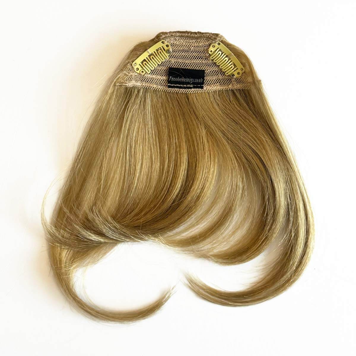 Blonde hair extension with a mesh cap on a white background. Clip in fringe hairpiece/clip-in curtain bangs, with long, face framing wisps: Sabrina blonde 24H613