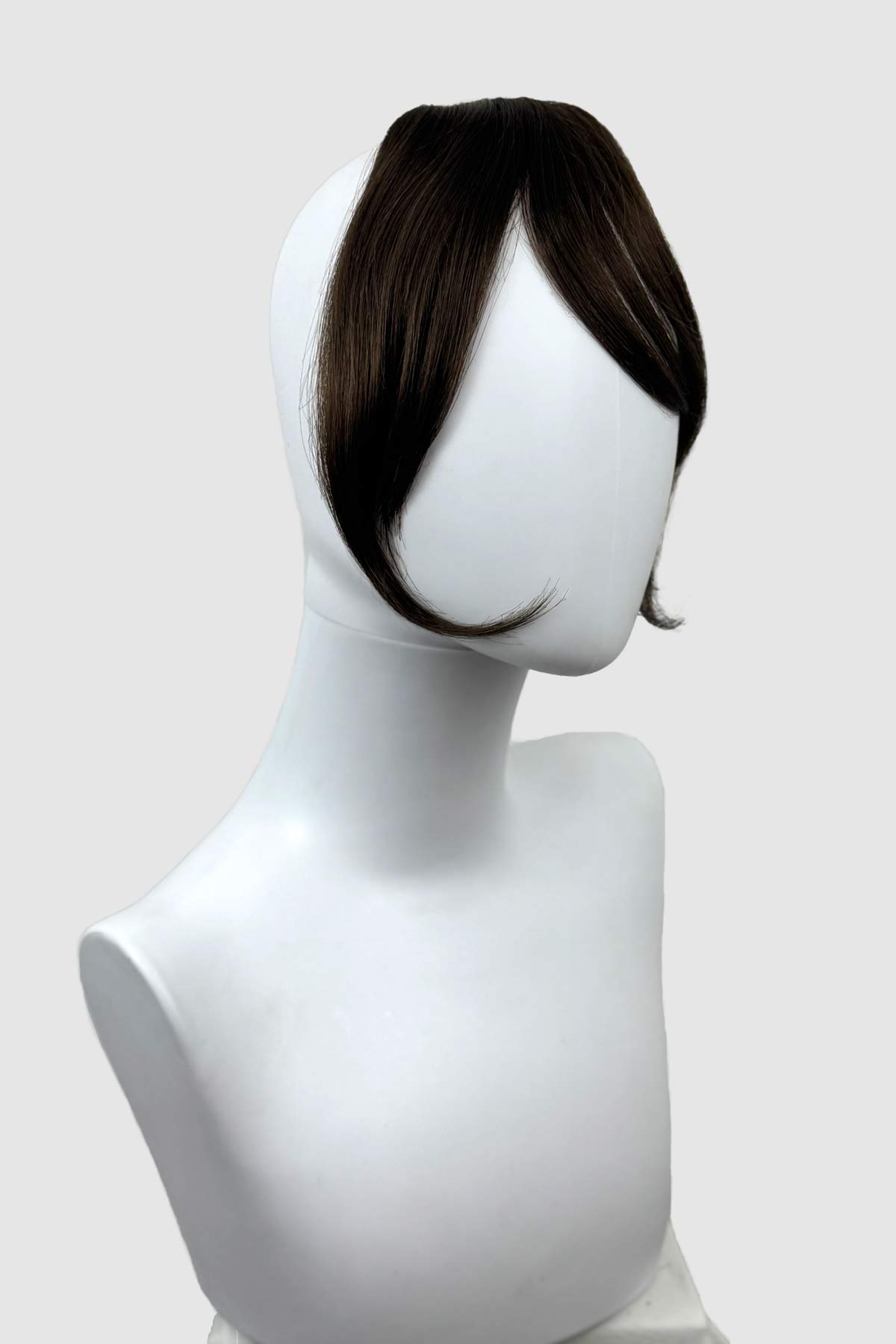 Mannequin head with a brown hair clip-in extension on a white background. Clip in fringe hairpiece/clip-in curtain bangs, with long, face framing wisps: Sabrina chestnut brown 8