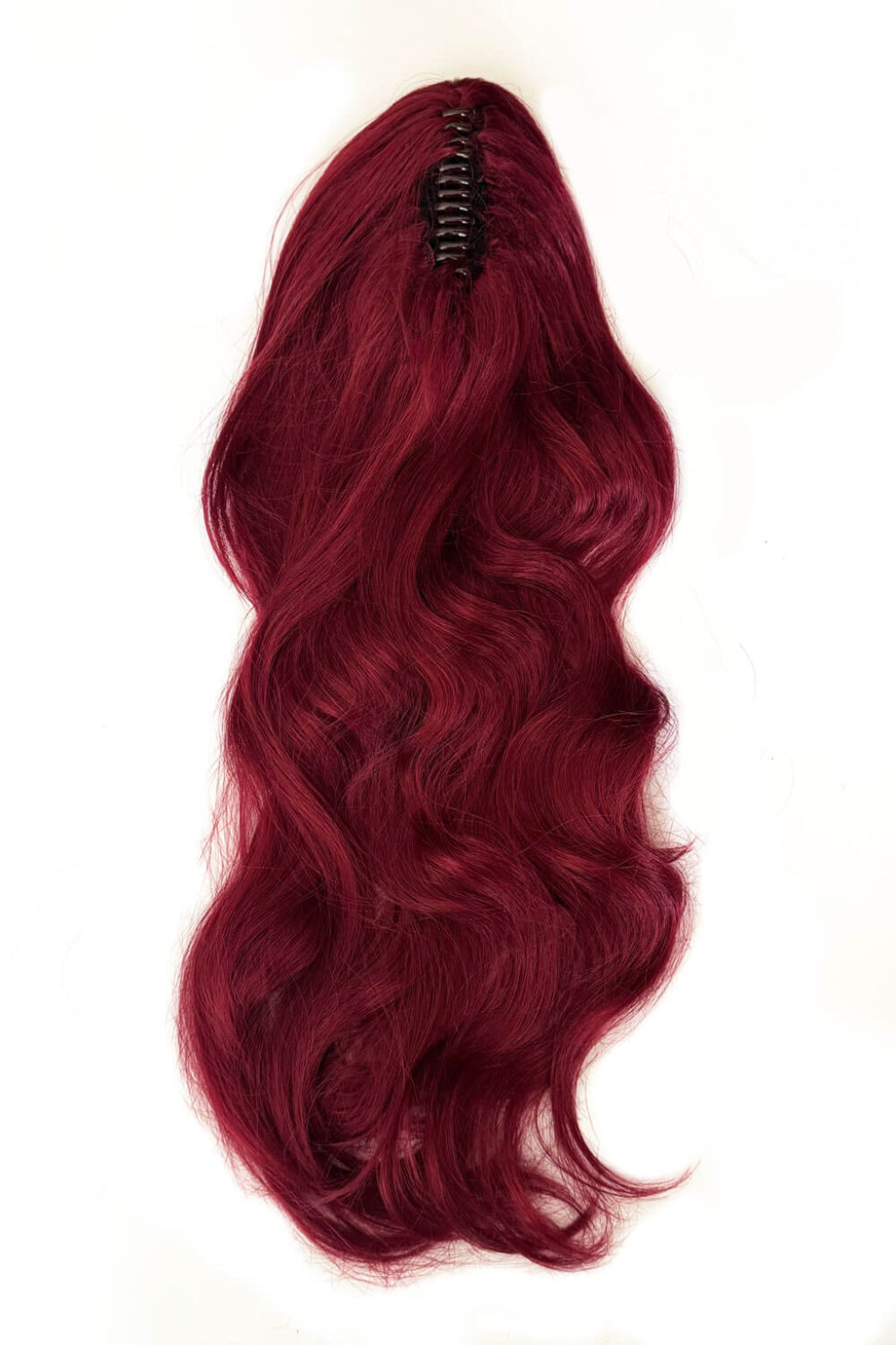 Red hair extension with a clip on a white background