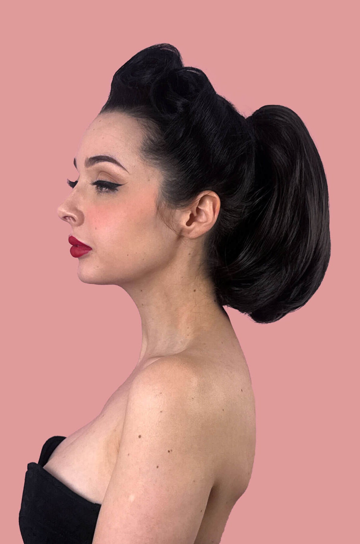 Woman with short ponytail extension hairpiece, straight, full & bouncy: Tanaya black 1B