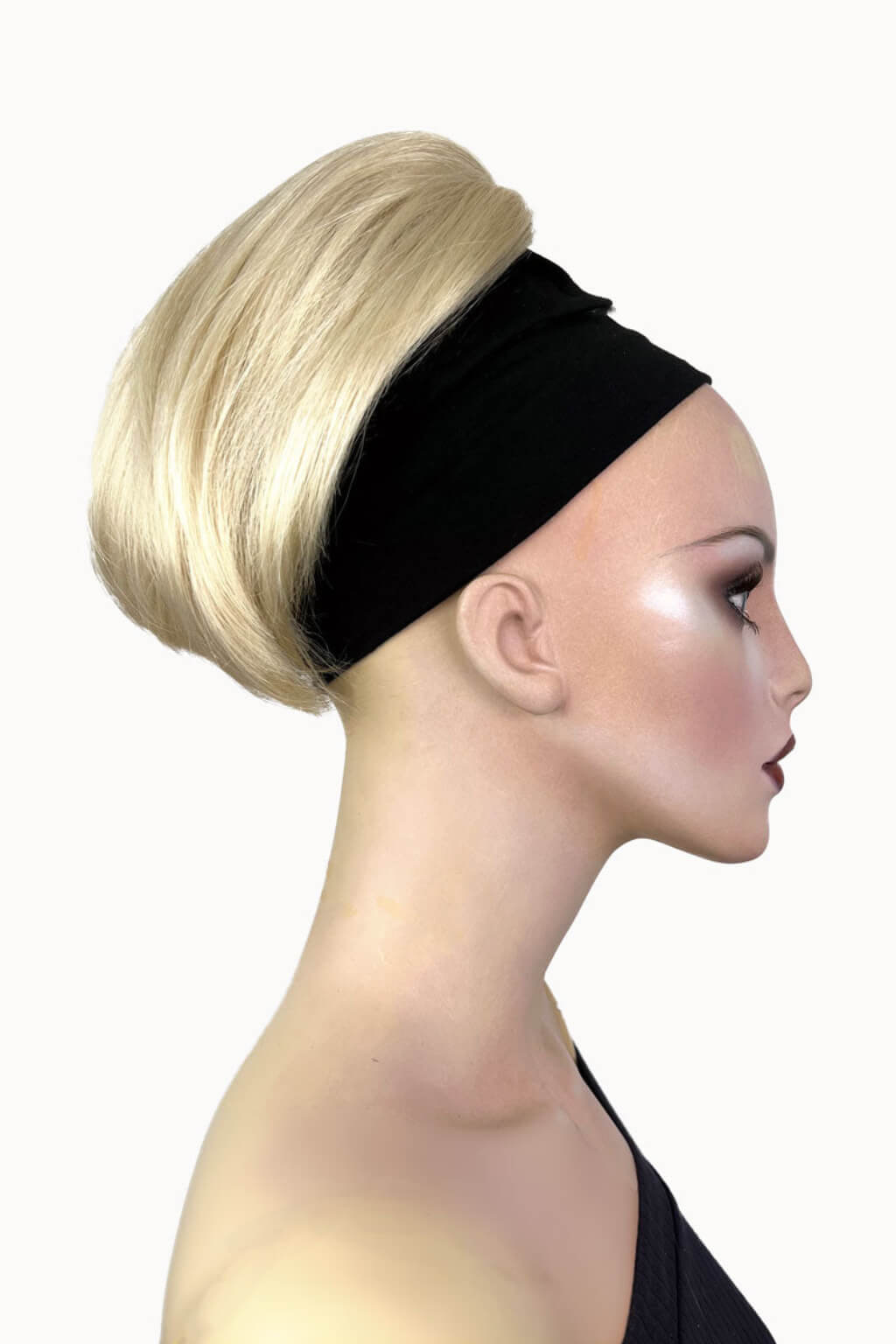 A woman showcasing a short ponytail extension hairpiece in a straight, full, and bouncy style. Short ponytail extension hairpiece, straight, full & bouncy: Tanaya blonde 613