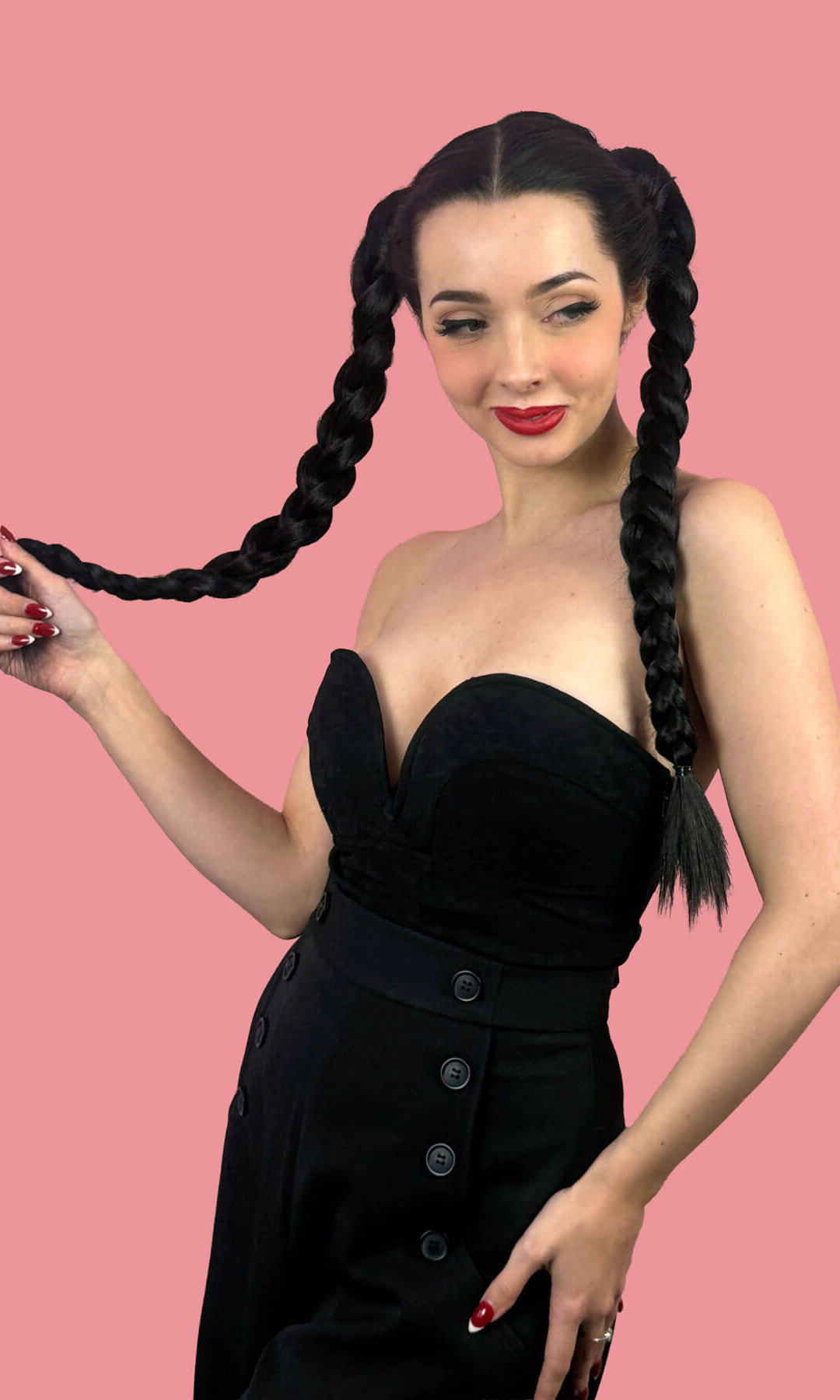 Woman with long braided hair wearing a black dress. Long double plaited ponytail hairpiece: Martha black 1B