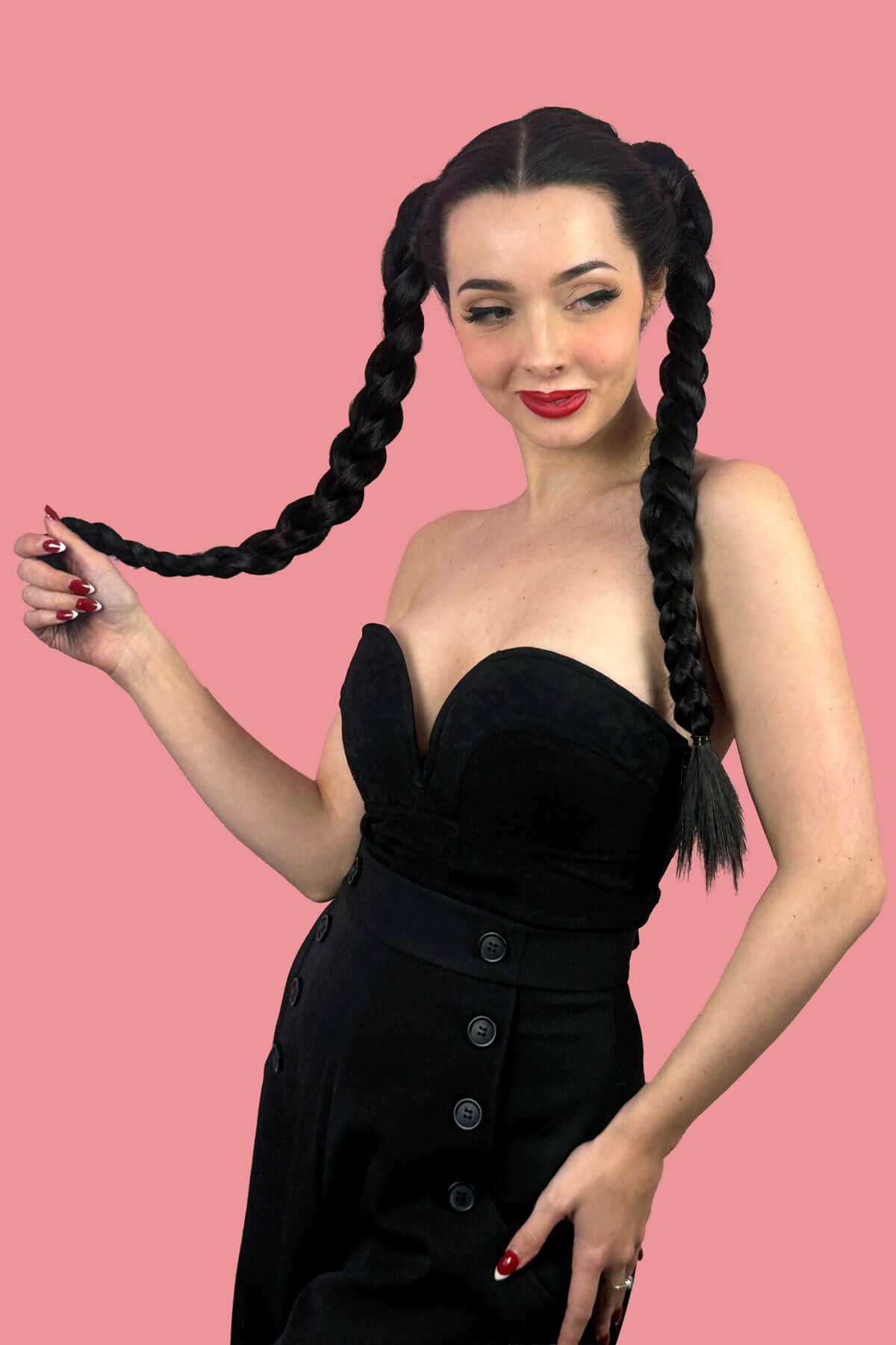 Woman with long braided hair wearing a black dress. Long double plaited ponytail hairpiece: Martha ginger
