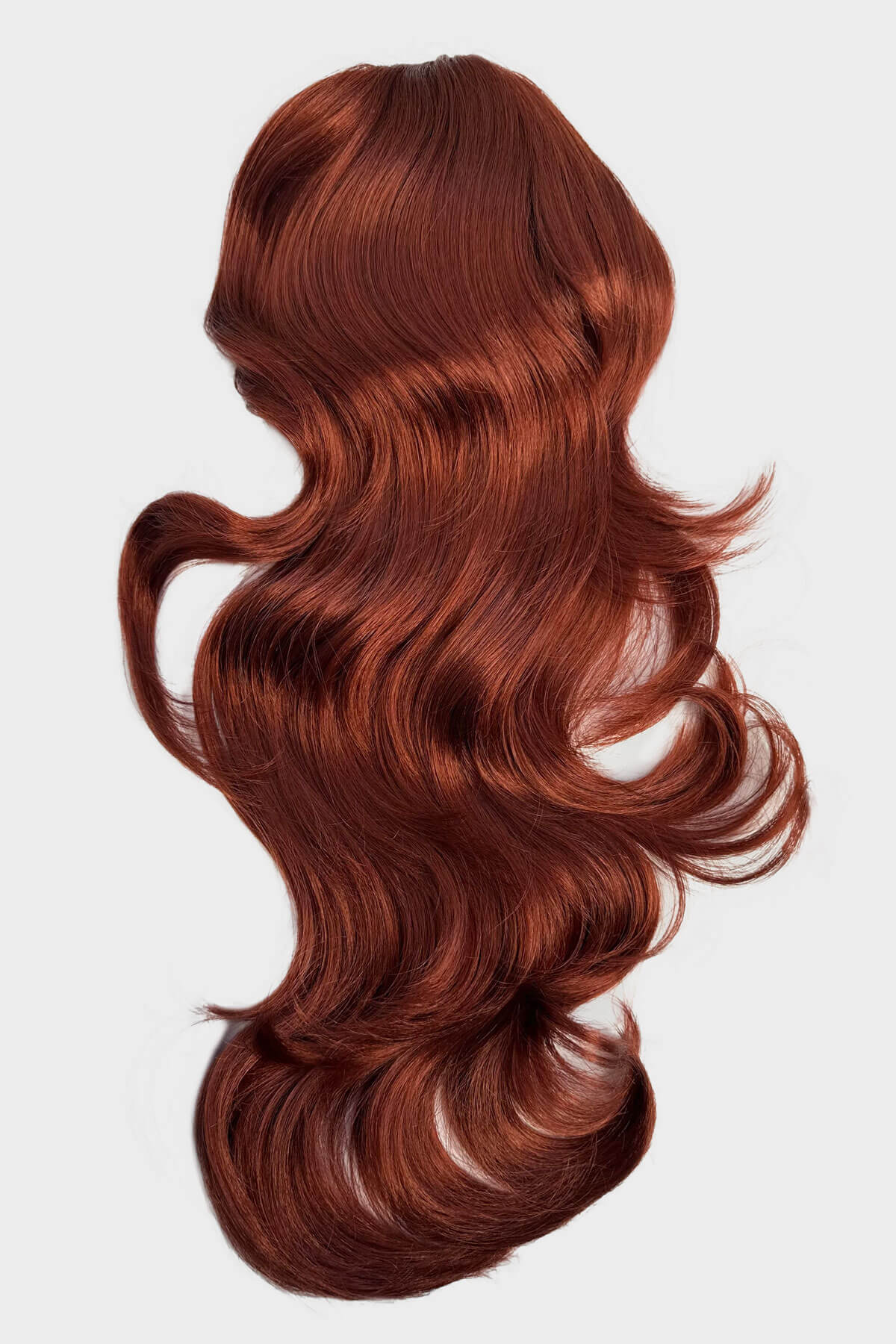 Reddish-brown hair extension on a white background. Double volume hairpiece extension: Naomi copper red 130