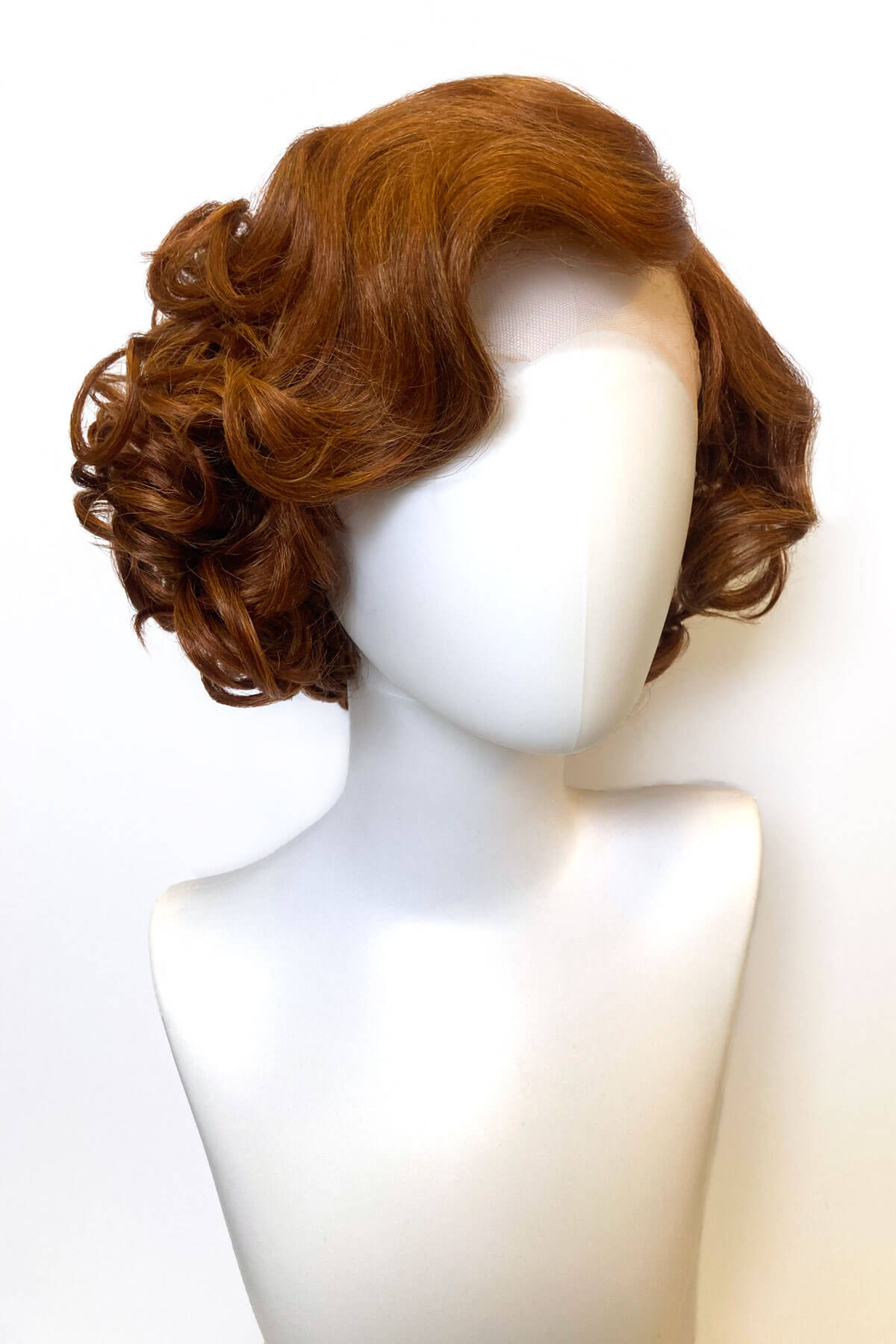 Brown wig on a mannequin head against a white background. Red, auburn & blonde pinup wig, lace front, vintage style: Ginny
