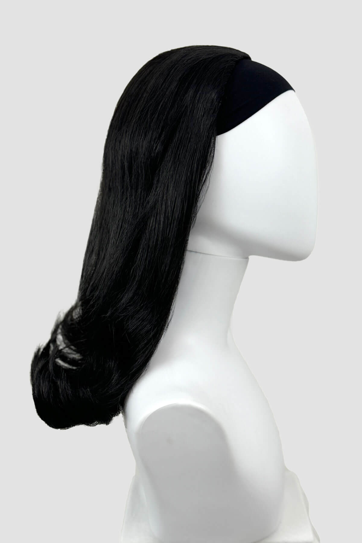 Black half wig on a mannequin head against a white background. 1960s half wig hairpiece, flicked, hair flip: Philippa black 1B