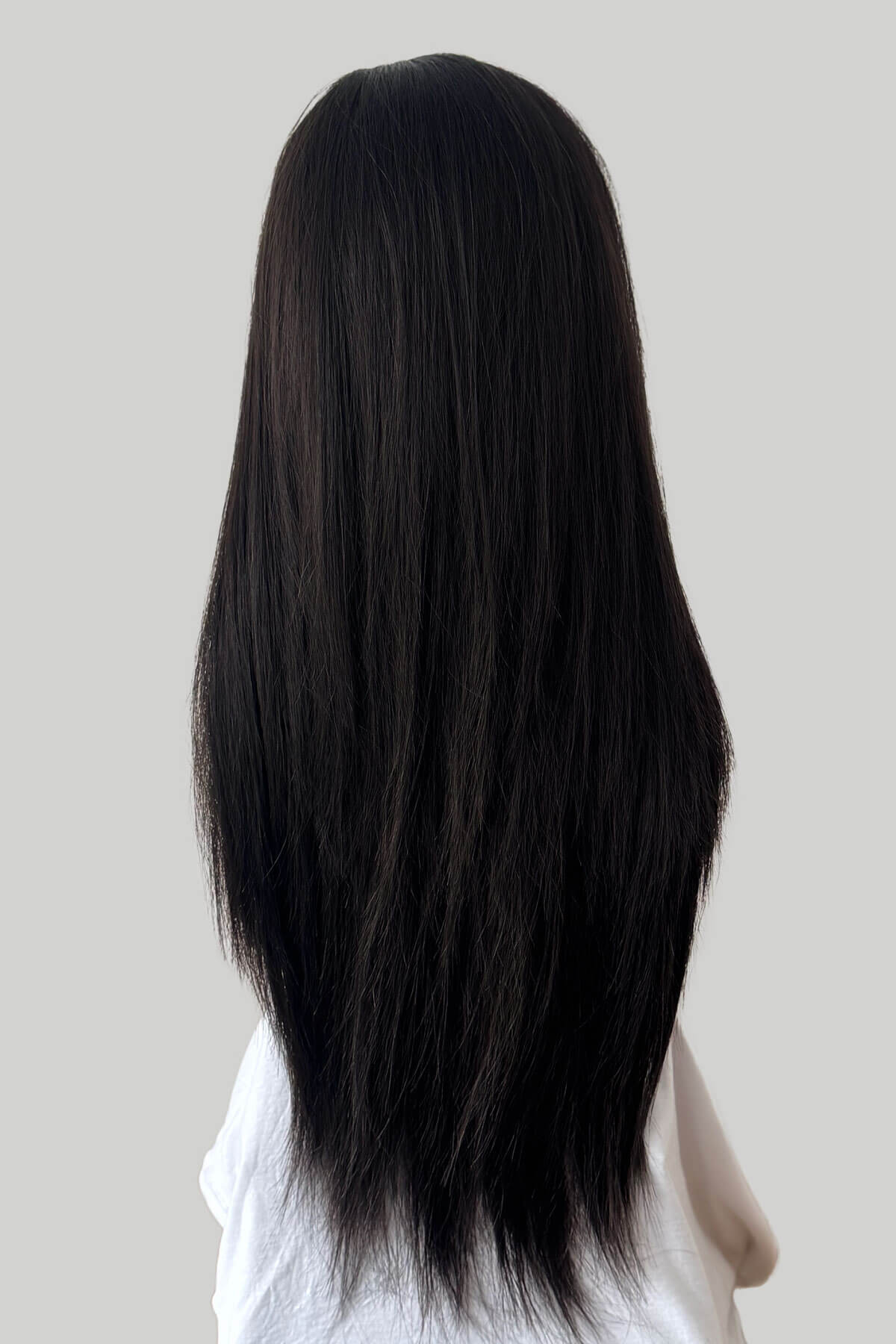 Dark brown hair extension on a white mannequin head against a light gray background. Straight brown half wig hairpiece extension, long: Faye dark brown 4