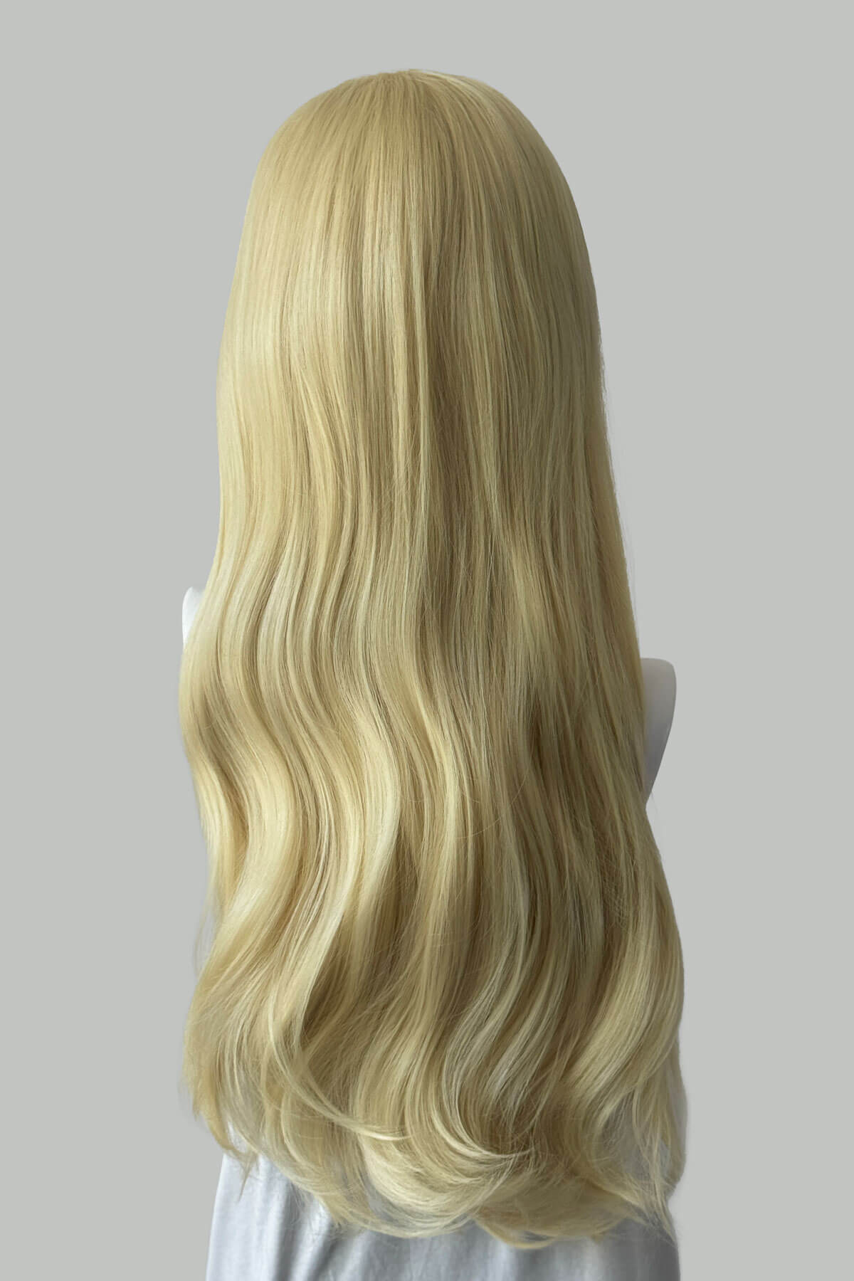 Blonde wig on a mannequin head against a plain background. Kate - Heat Styleable Extra Long, Gentle Wave Half Wig blonde 613