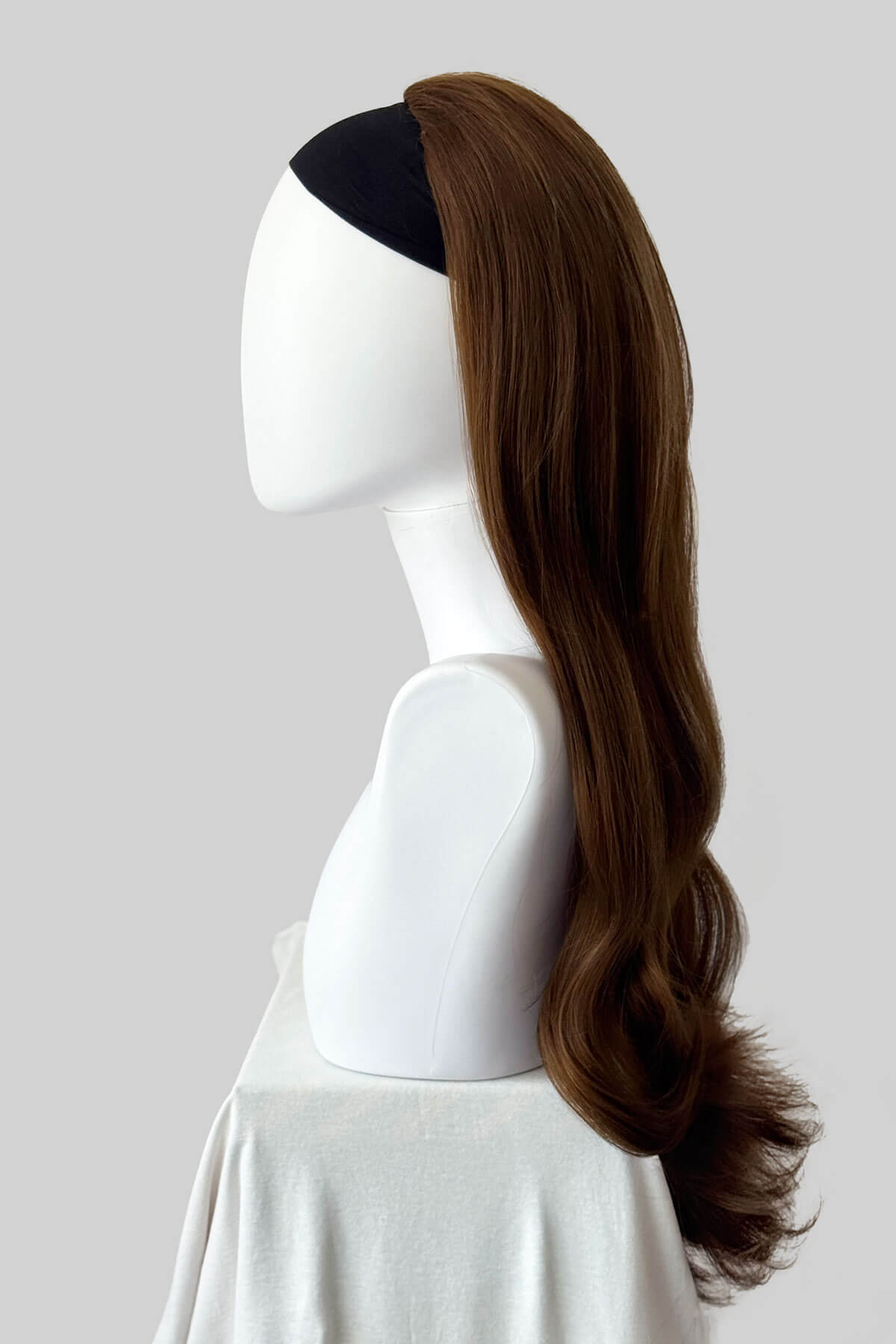 Long, light brown wig on a plain background. Kate - Heat Styleable Extra Long, Gentle Wave Half Wig dark light brown 12