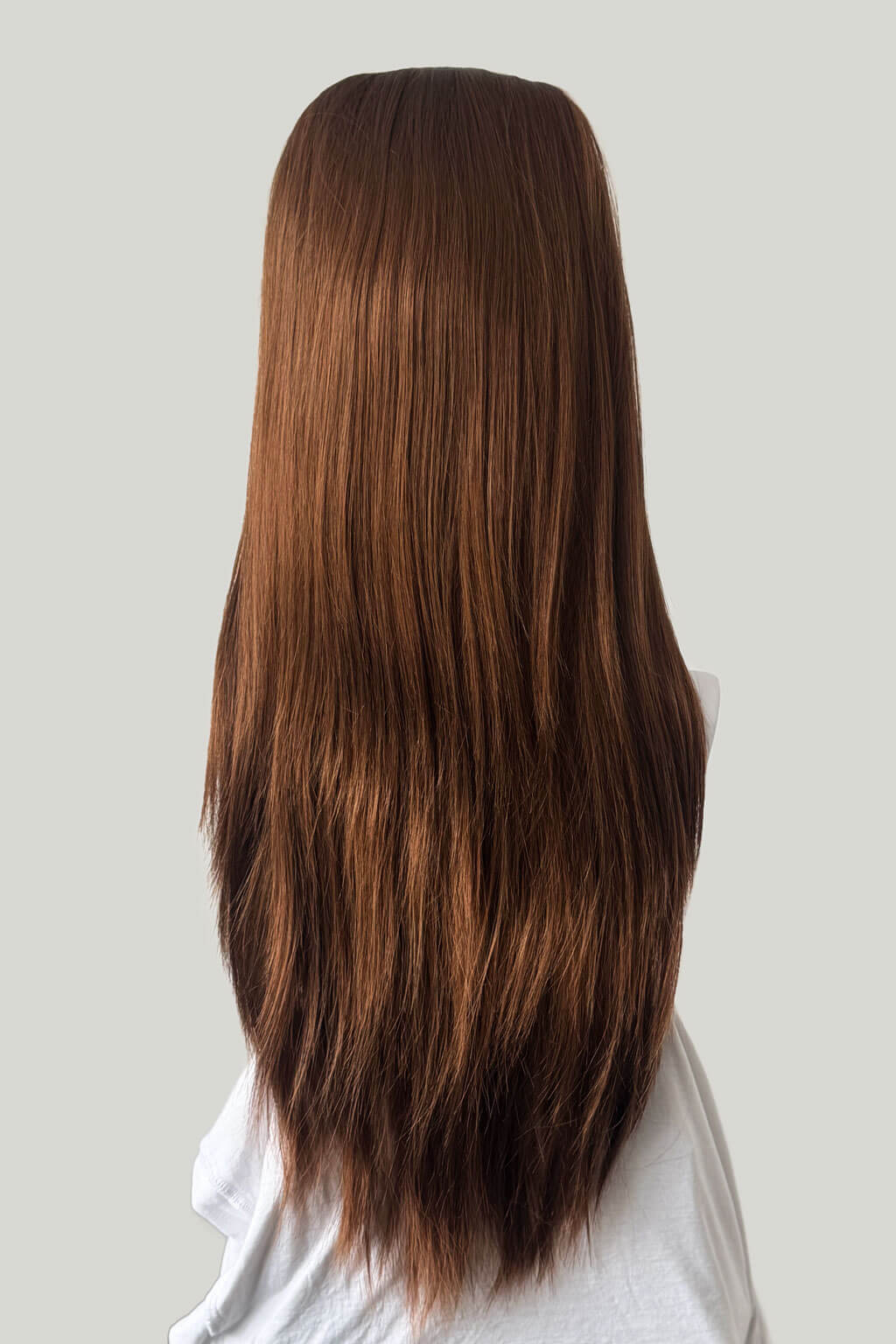 Long auburn hair on a mannequin head against a plain background. 1960s style hair, high crown long straight half wig: Andrea auburn 30