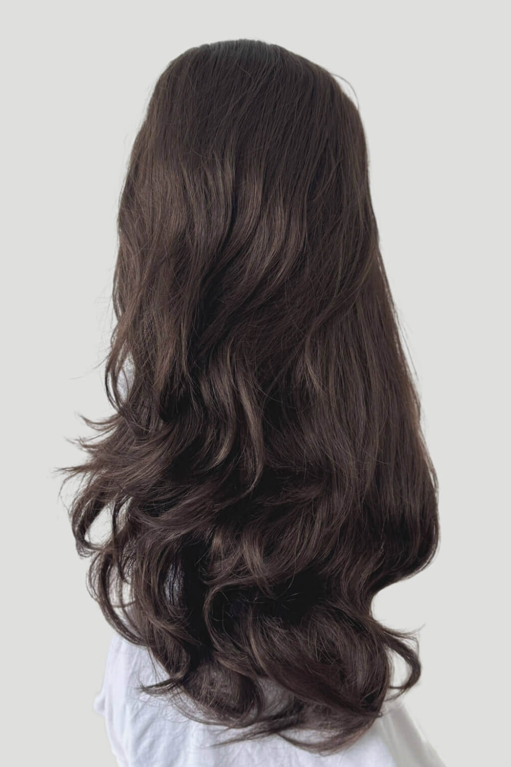Long, wavy brown hair on a white background. High crown long, wavy half wig and volume ring: Bardot chestnut brown 8