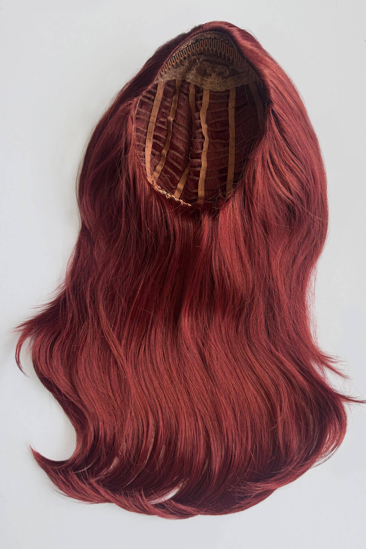 A long, wavy wig in a deep auburn red colour, displayed from the top to show the internal attachment structure against a plain light grey background. Claudia - Volume Boosting Long Gentle Bouncy Layered Half wig copper and dark cherry red 350/39