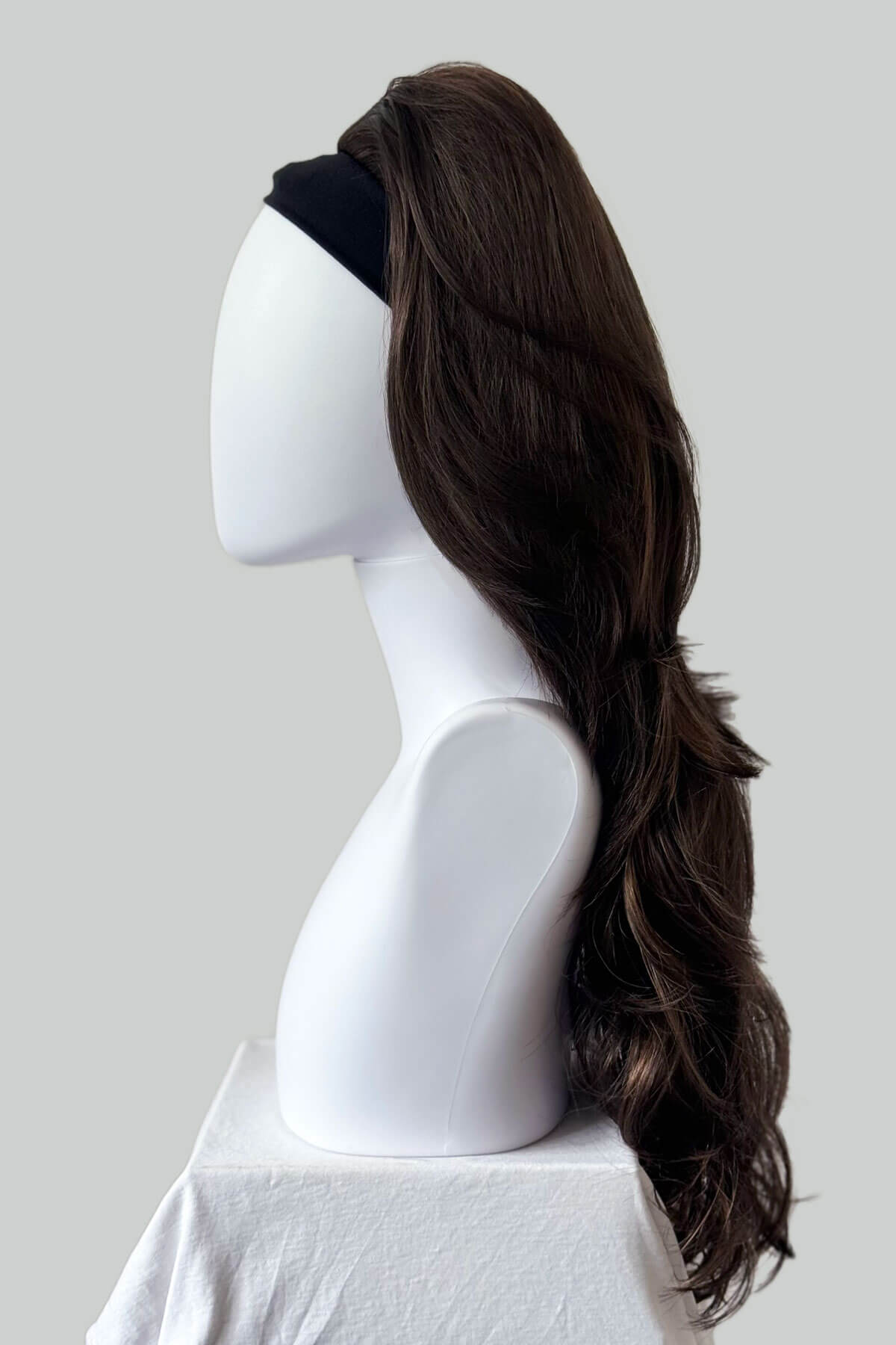 Mannequin head with a long brown wig on a white background. High crown long layered half wig and volume ring Helena brown and blonde 8H27