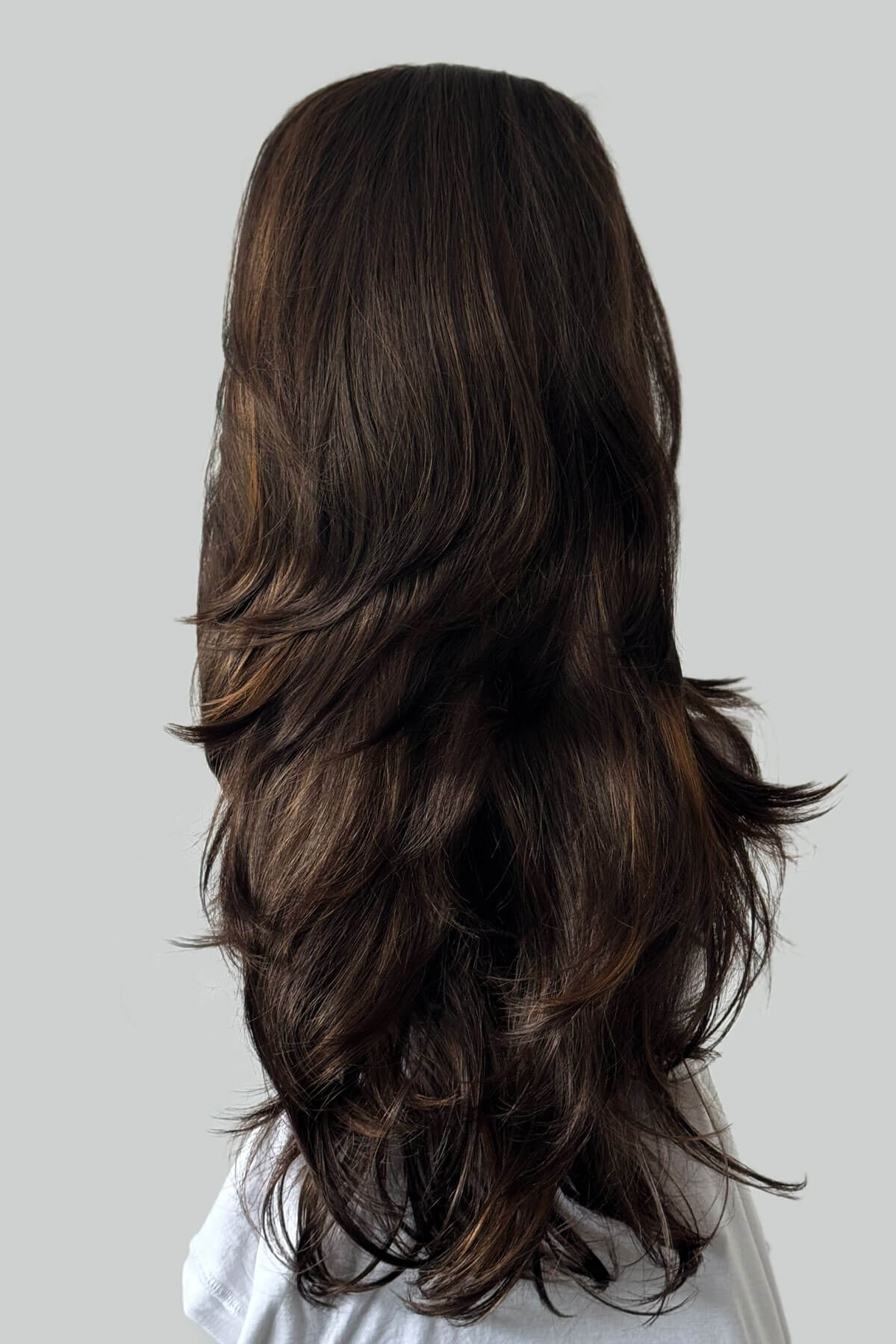 Long, wavy brown hair on a white background. High crown long layered half wig and volume ring Helena brown and blonde 8H27