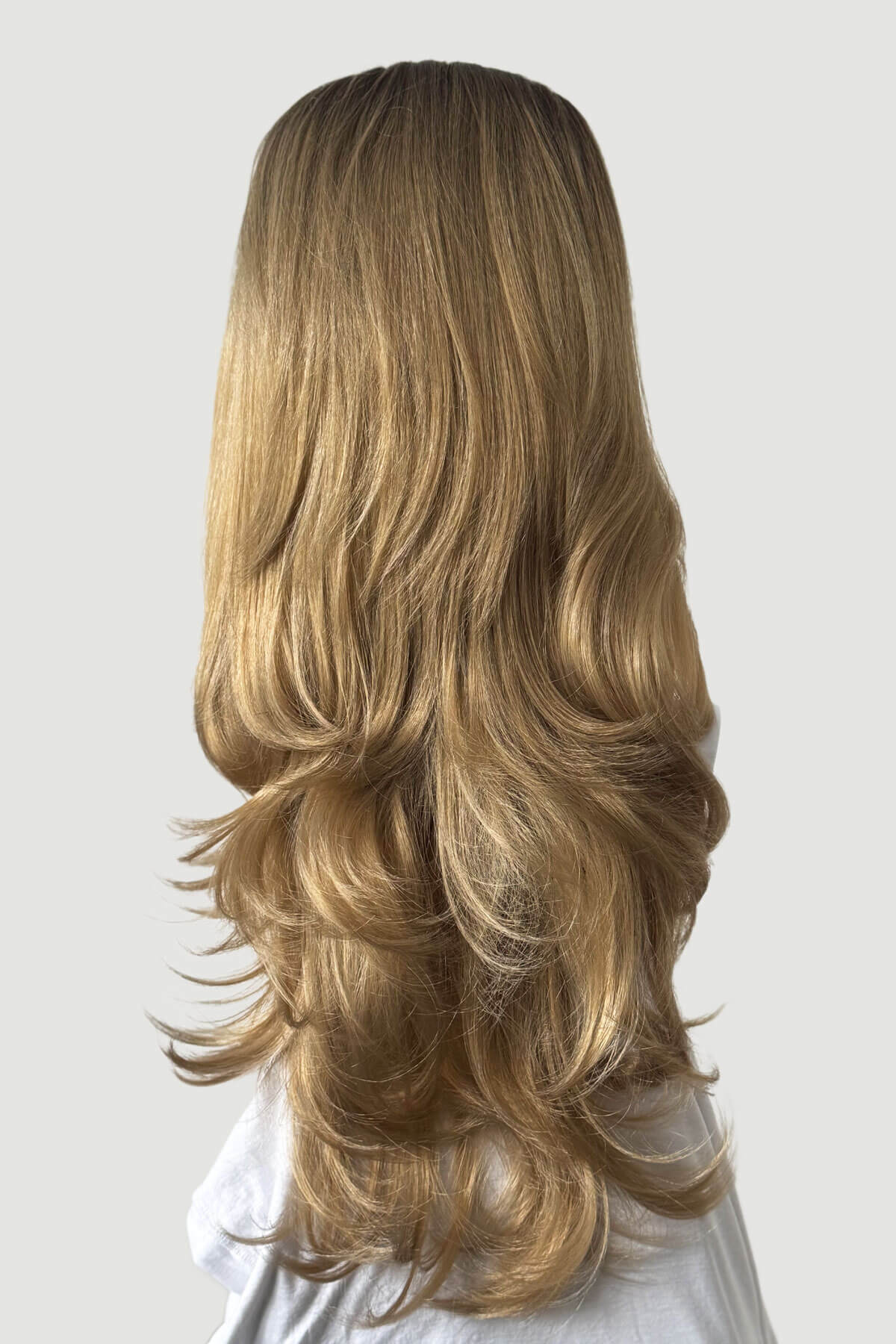 Long wig on a plain background. High crown long, layered half wig and volume ring: Helena brown to blonde 8TN24