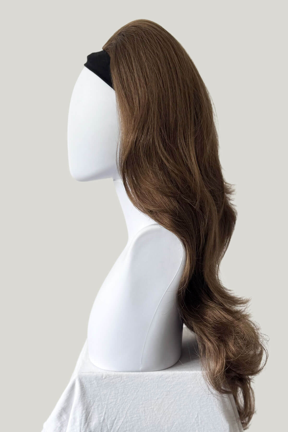 Mannequin head with long brown wig on a plain background. High crown long, layered half wig and volume ring: Helena light brown 12