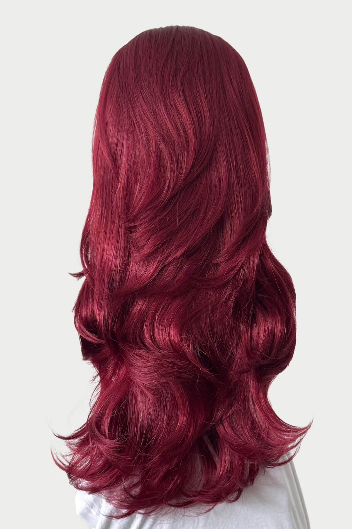 Long, wavy red hair on a white background. High crown long, layered half wig and volume ring: Helena cherry red 39