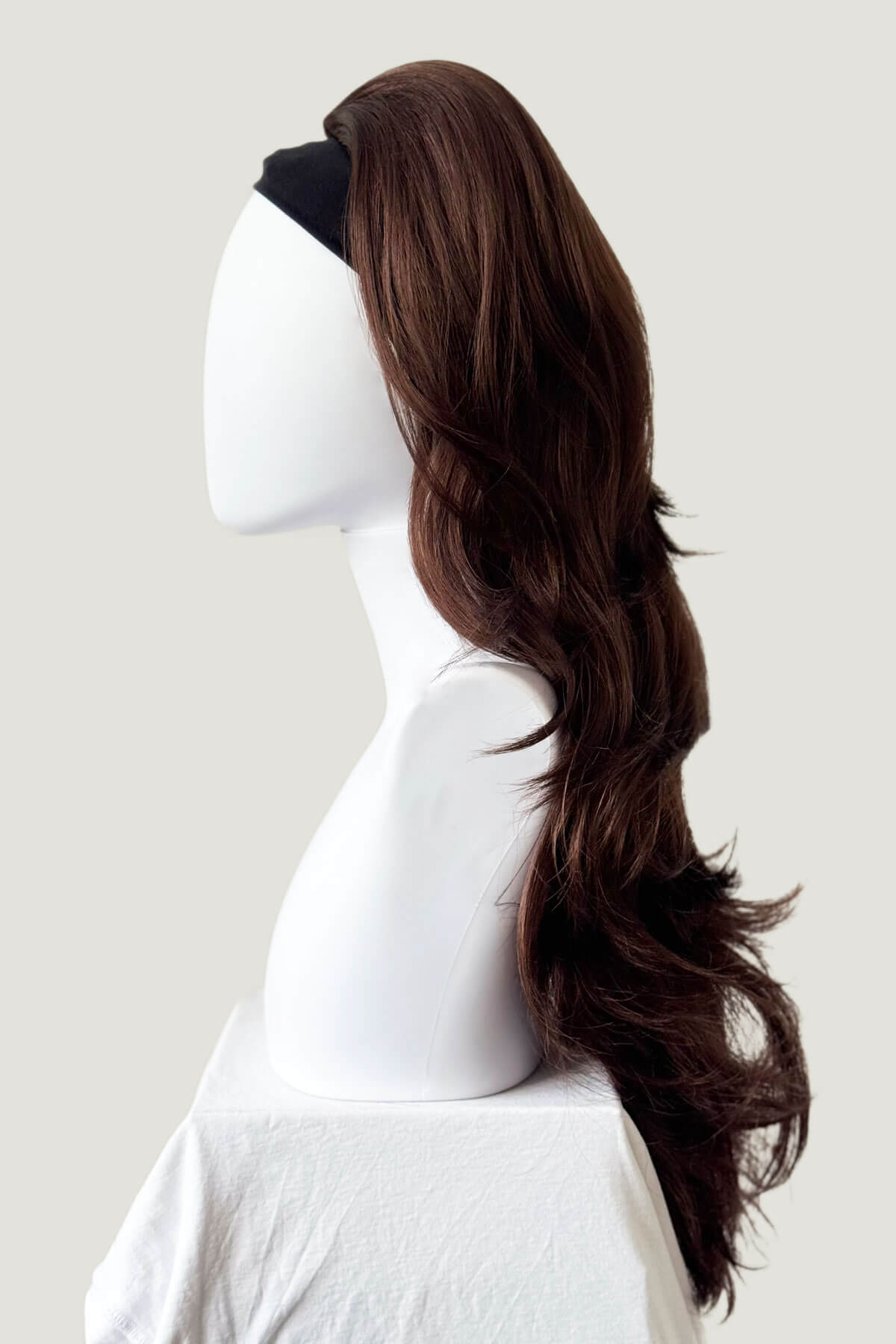 Long reddish brown wig on a mannequin head against a plain background. High crown long, layered half wig and volume ring: Helena reddish brown 33