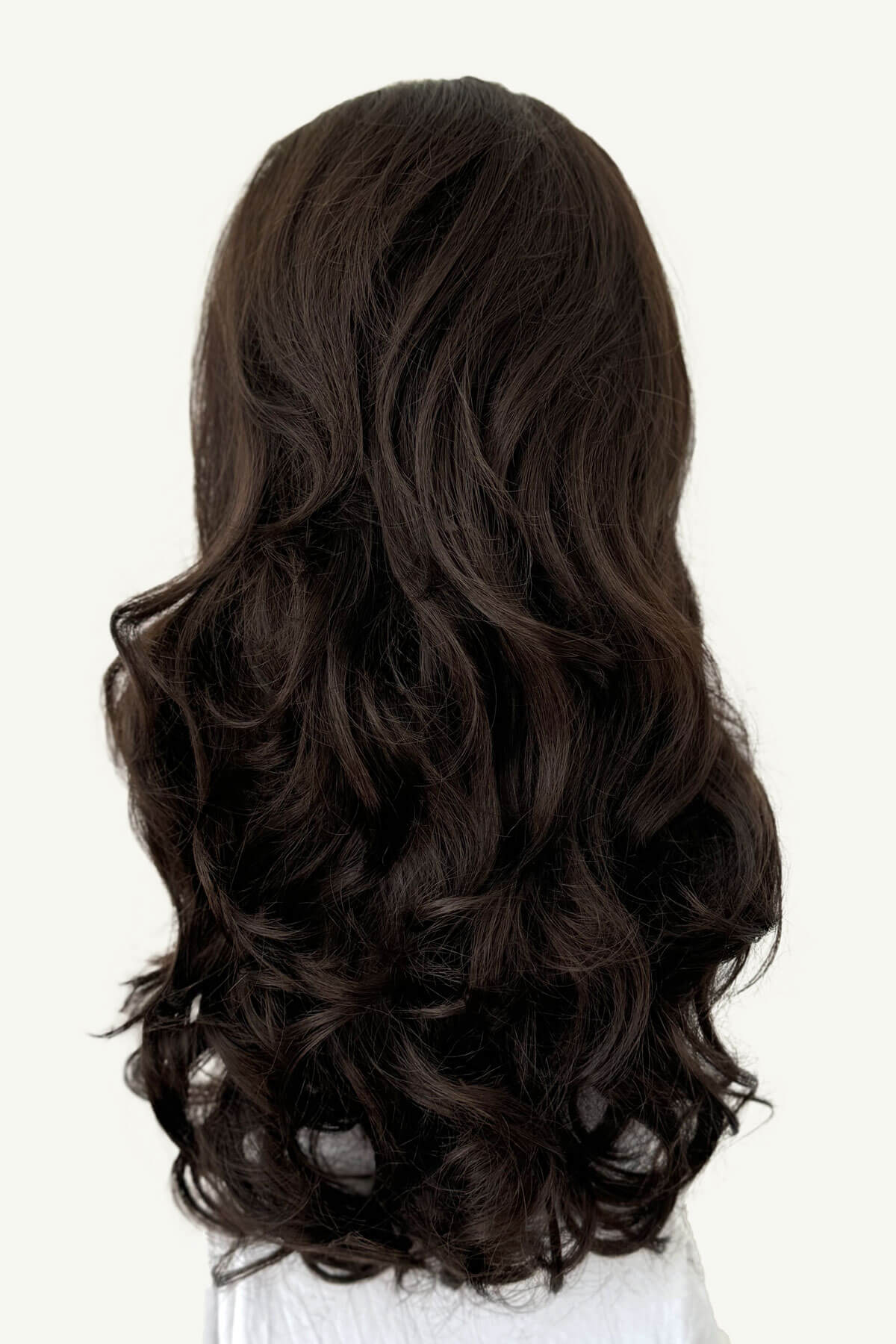 Dark brown hair extension on a white background. Curly brown half wig hairpiece: Susan