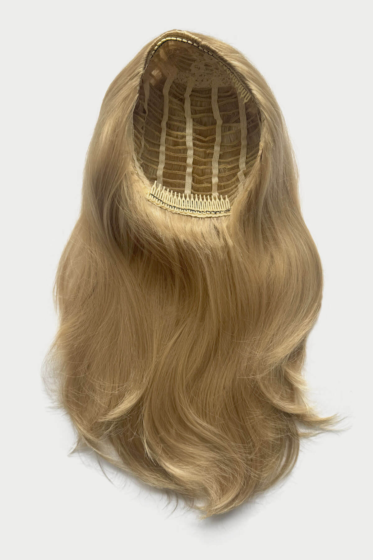Blonde hair wig on a white background. Straight blonde half wig hairpiece (3/4 wig), layered: Autumn blonde 24H613