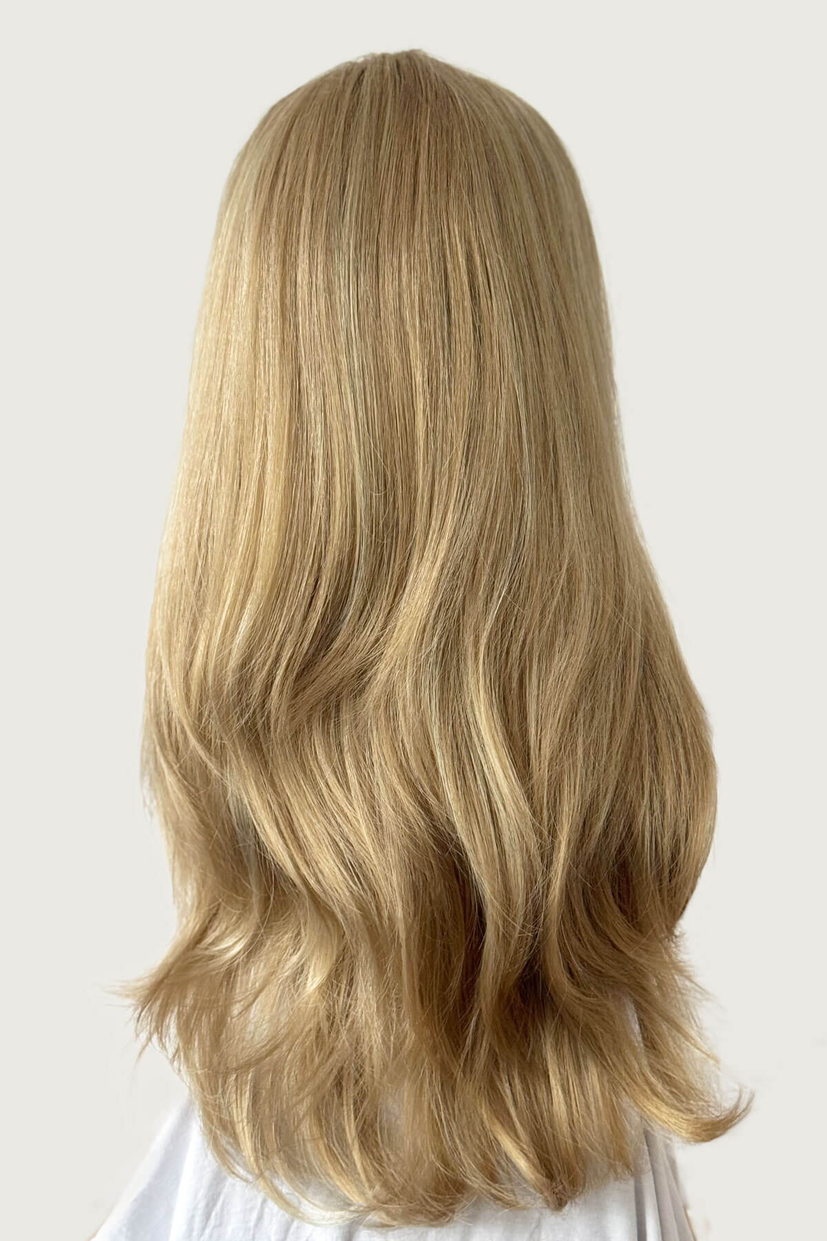 Blonde wig with wavy hair on a white background. Straight blonde half wig hairpiece (3/4 wig), layered: Autumn blonde 24H613