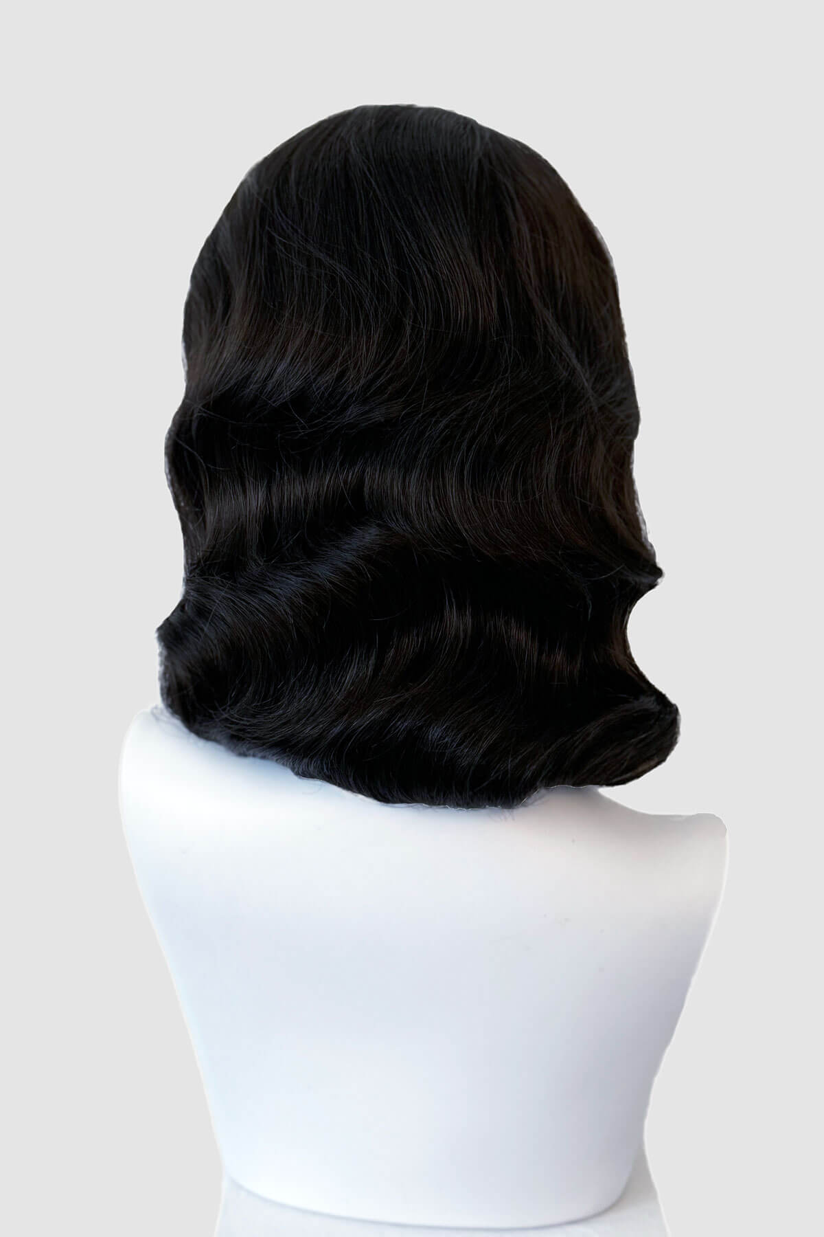 Black wig on a mannequin head against a white background. 1940s style half wig hairpiece with beautiful marcel waves: Virginia dark brown 4