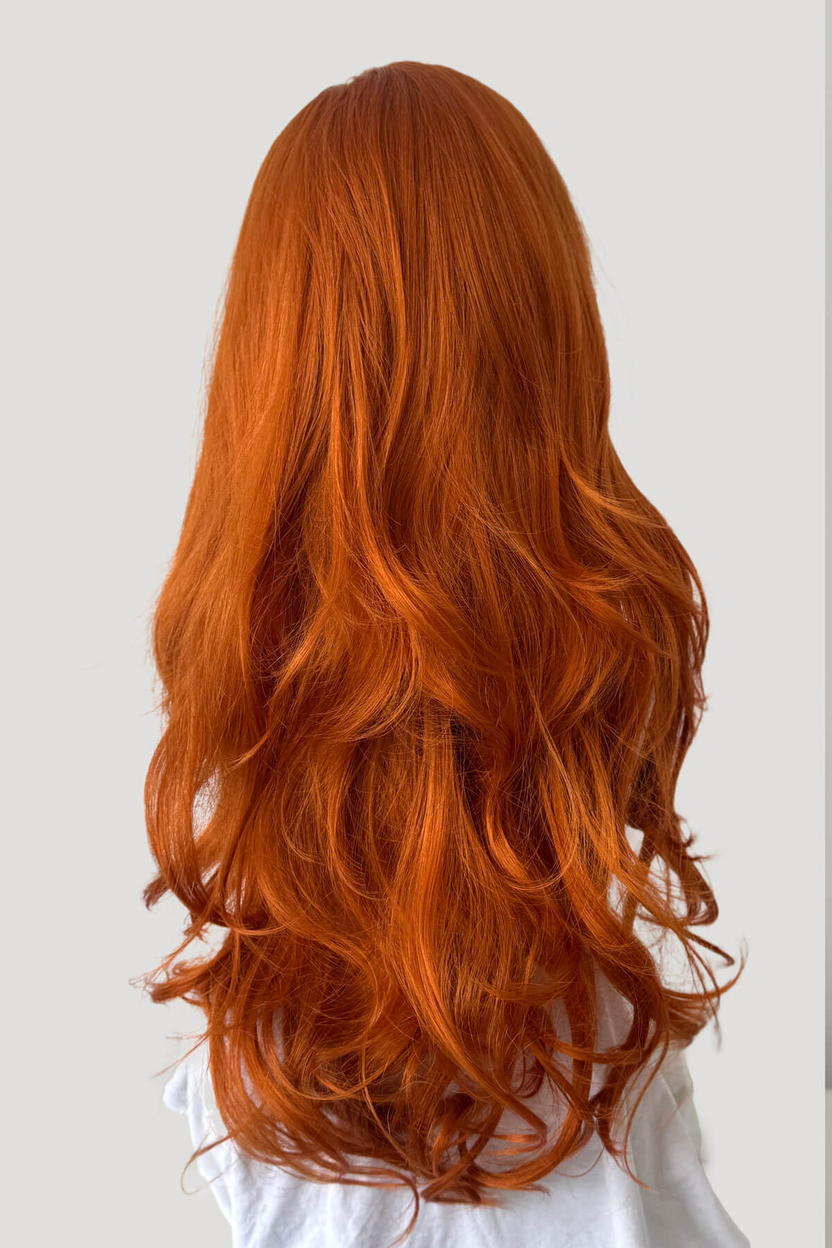 Long, wavy ginger hair on a white background, Ginger half wig (3/4 hairpiece) with long waves: Keegan