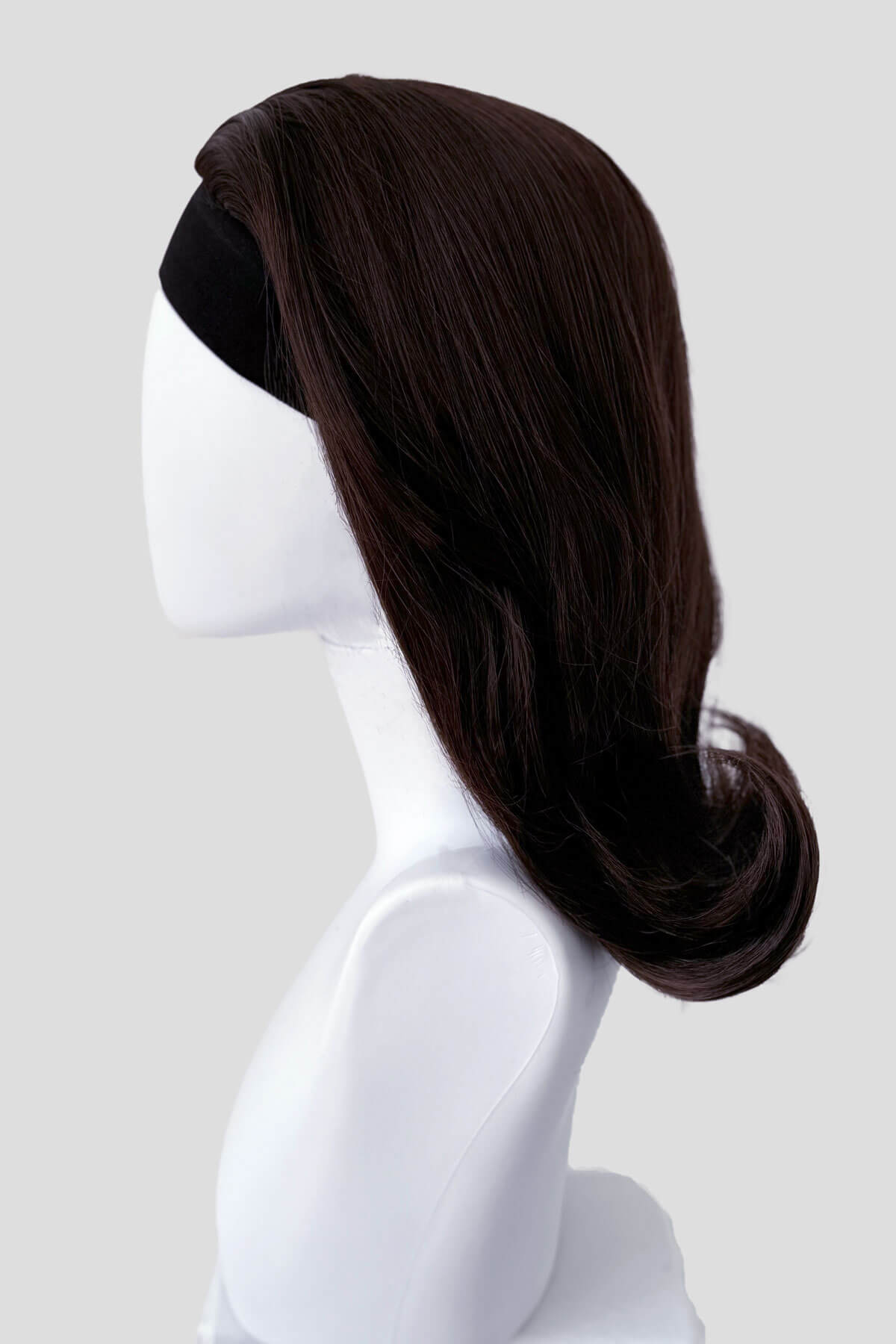 Dark brown wig on a white mannequin head against a light gray background. 1960s half wig hairpiece, flicked, hair flip: Philippa dark chocolate brown 6