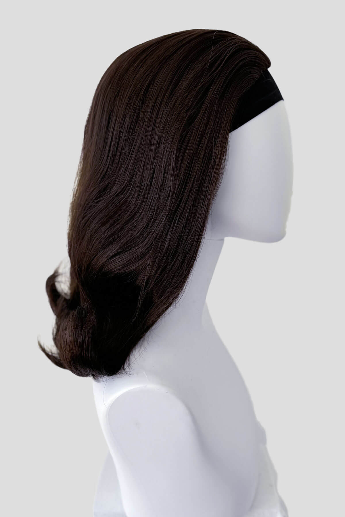 Dark brown wig on a mannequin head against a white background. 1960s half wig hairpiece, flicked, hair flip: Philippa dark chocolate brown 6