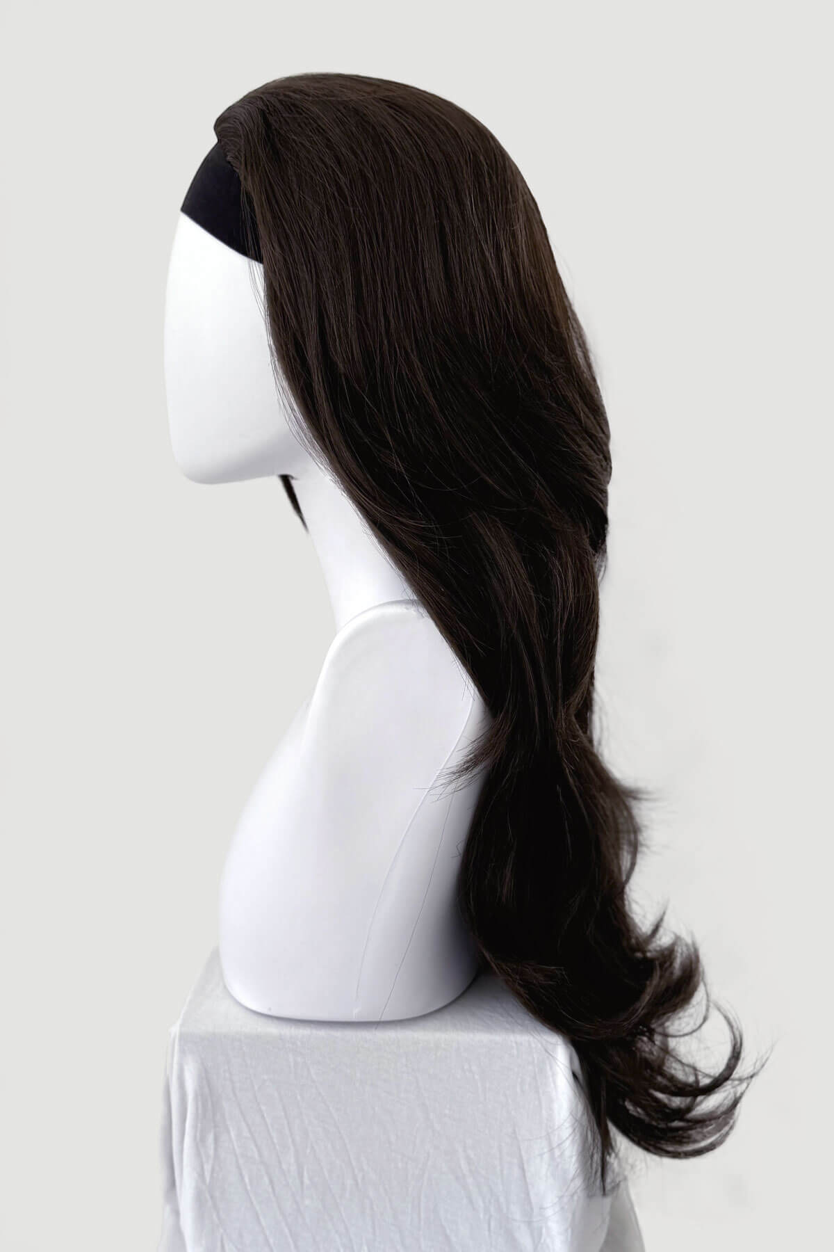 Dark brown wig on a mannequin head against a white background, Brown half wig hairpiece (3/4 wig), layered, wavy: Simone dark brown 6