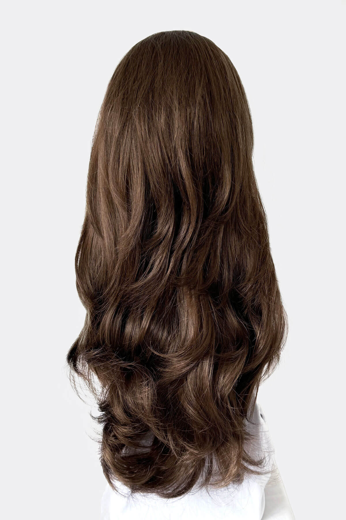 Long, wavy brown hair extension on a white background. Brown half wig hairpiece (3/4 wig), layered, wavy: Simone mocha brown 10