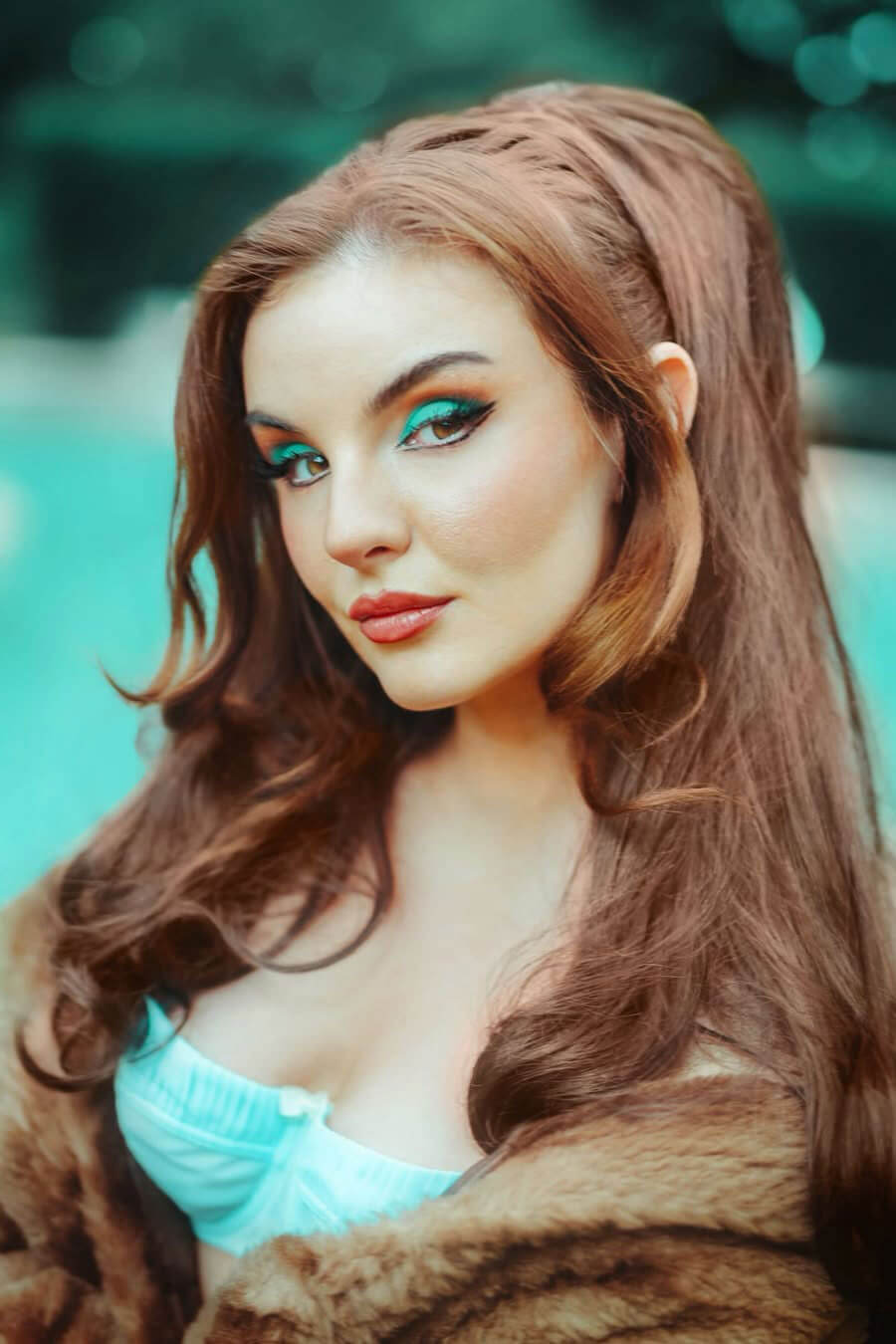 Woman with long brown hair and turquoise makeup wearing a fur coat. Retro high crown, half wig hairpiece, long with hair flip: Priscilla chestnut brown 8