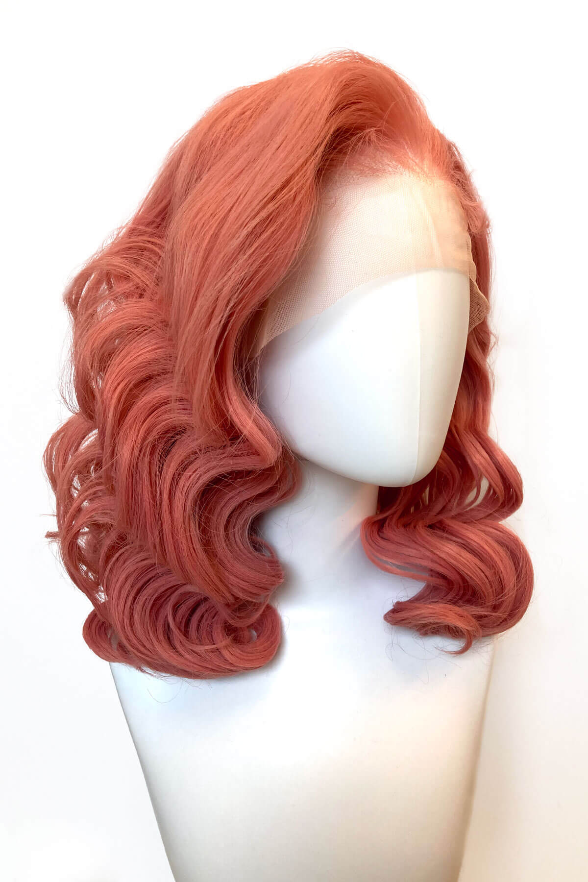 Pink wig on a mannequin head against a white background. Pink pinup wig, lace front, vintage style: Catalina