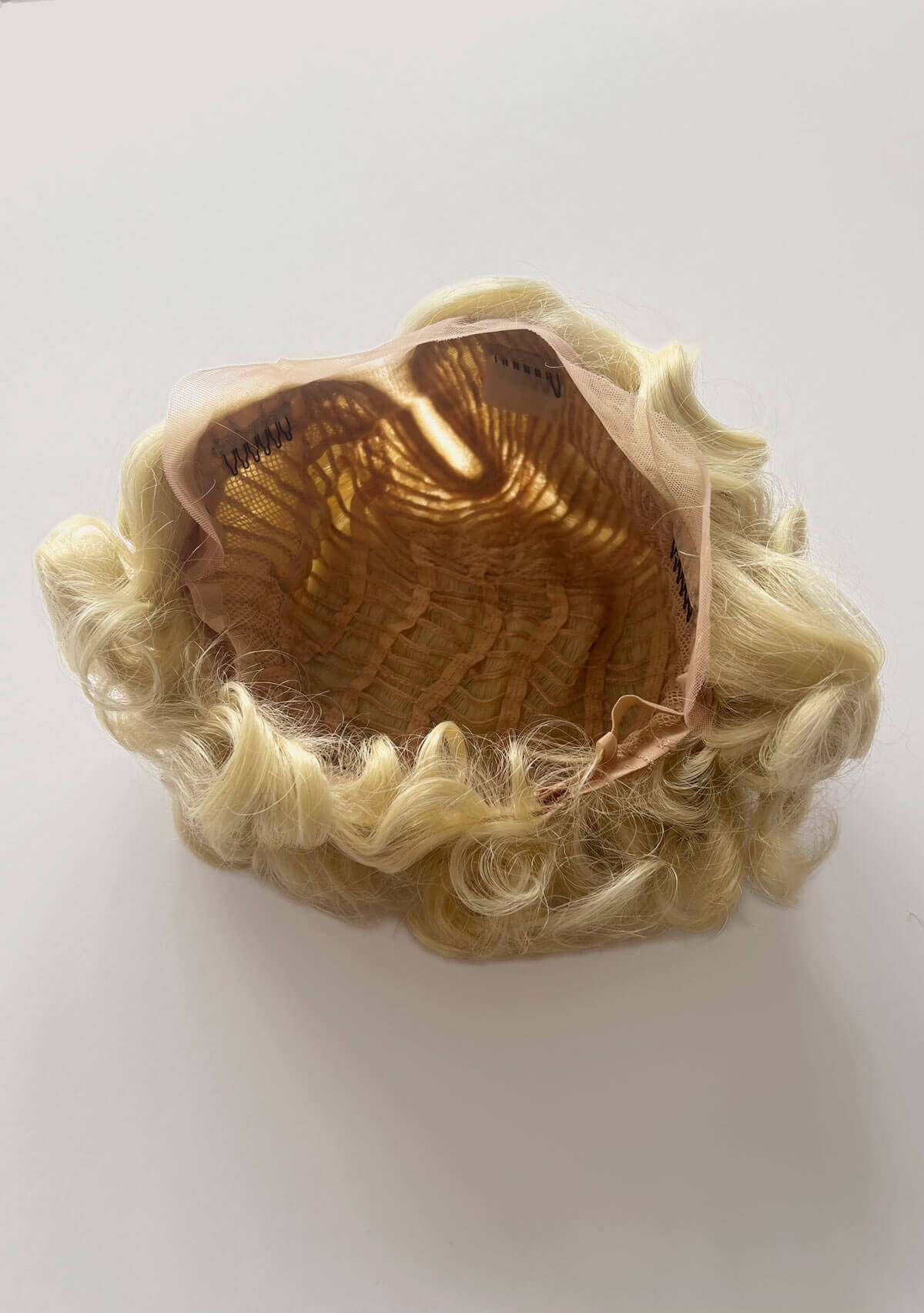 Blonde wig on a white background. Blonde pinup wig, lace front, vintage style: Odette