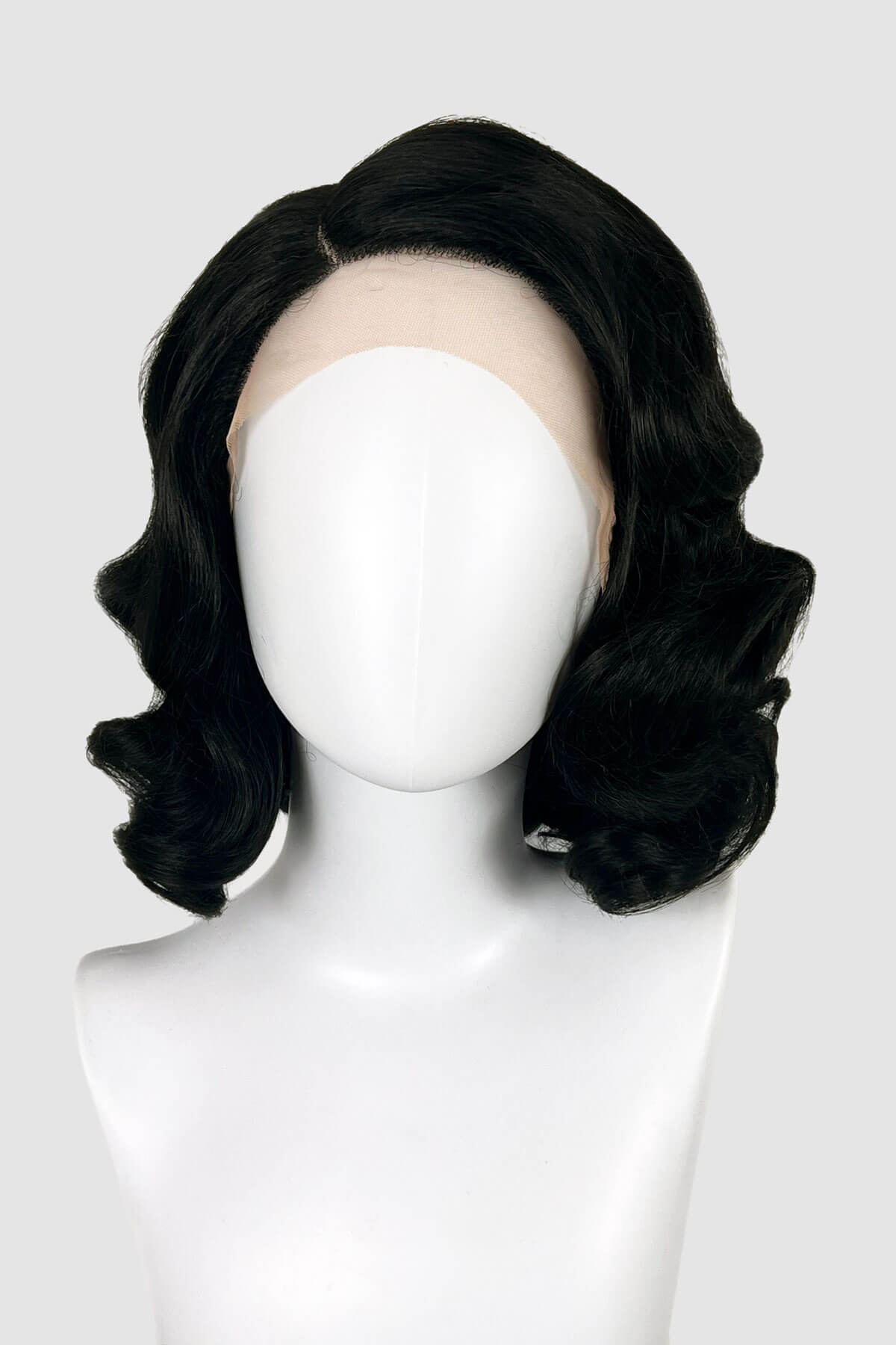 Black wig on a mannequin head against a white background. Black lacefront wig, pinup/vintage style, mid length with finger waves: Etta