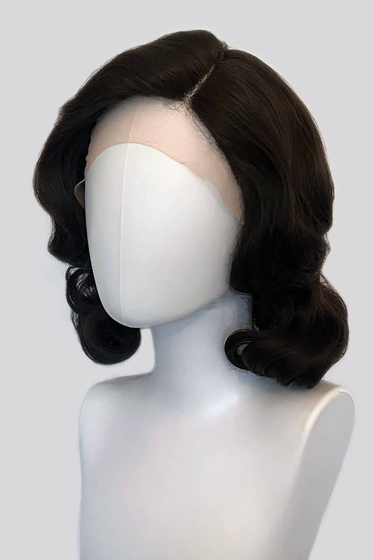 Black wig on a mannequin head against a white background. Brown lacefront wig, pinup/vintage style, mid length with finger waves: Agatha